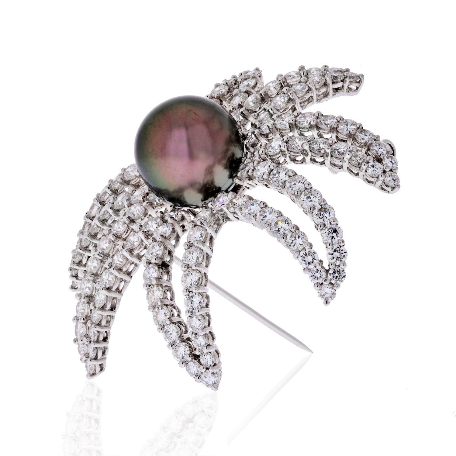 The Firework platinum brooch featuring a cultured pearl measuring 10 mm, enhanced by full-cut diamonds weighing a total of 5.50 carats. Brooch completed by a pin stem and catch.
Diamond Average Color: G-H-I
Diamond Average Clarity: VS
Diamond