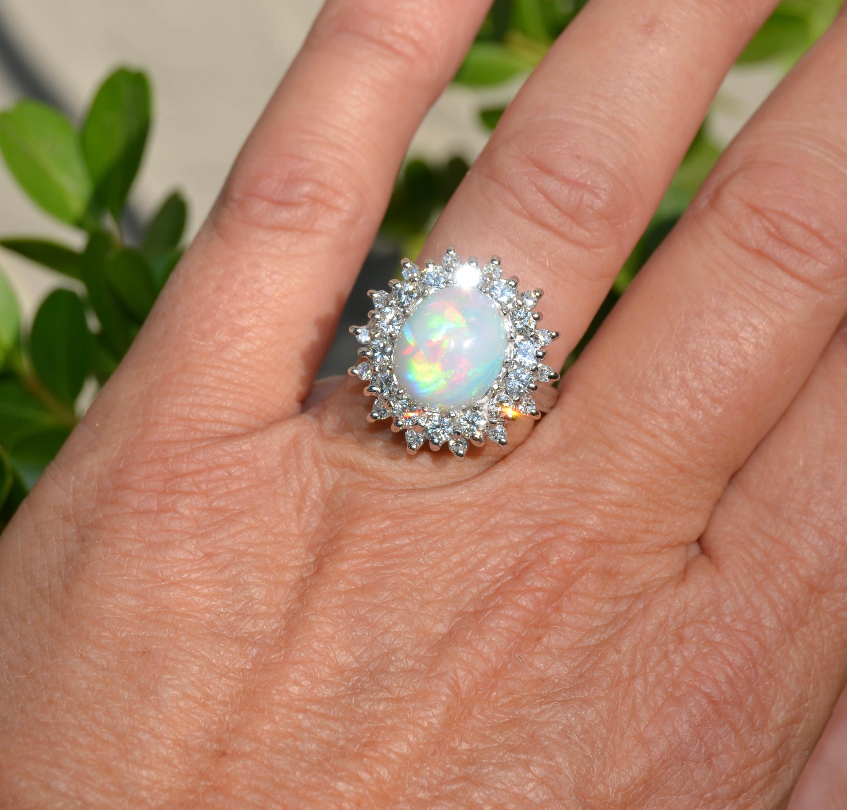 This is a firey opal ring. The color matrix is visible in almost all lighting conditions. The ring is currently a size 7 US. The center stone is a whole natural untreated opal. The color matrix is primarily Red, Blue, Yellow Green & Pink. It just