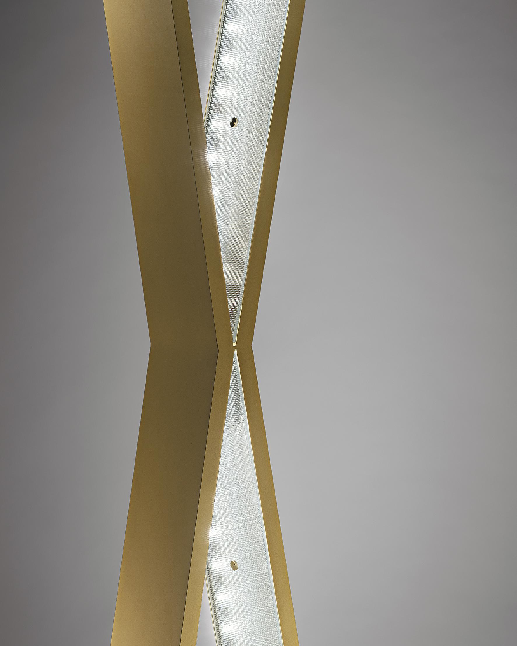 Please note that VAT is not included in the price.

A willowy brass X of which inner sides contain 12 LEDS, covered by sophisticated diamond cut glasses. Able to function as either a floor lamp or a suspension lamp, it has generous dimensions and