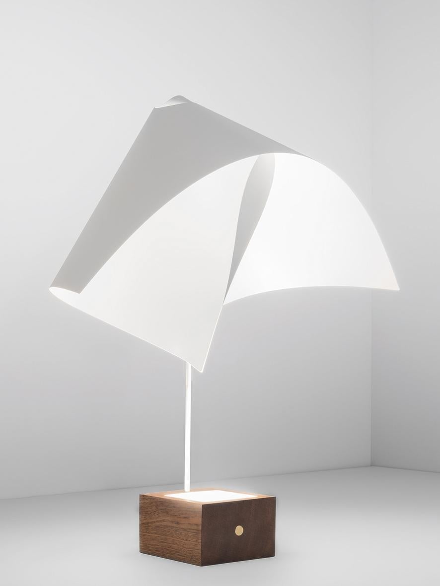 Please note that VAT is not included in the price.

Table lamp with indirect and reflected light, but also and especially a sculpture of wood and steel that once lit it is enriched with values and emotions. A soothing and calming light, of peaceful