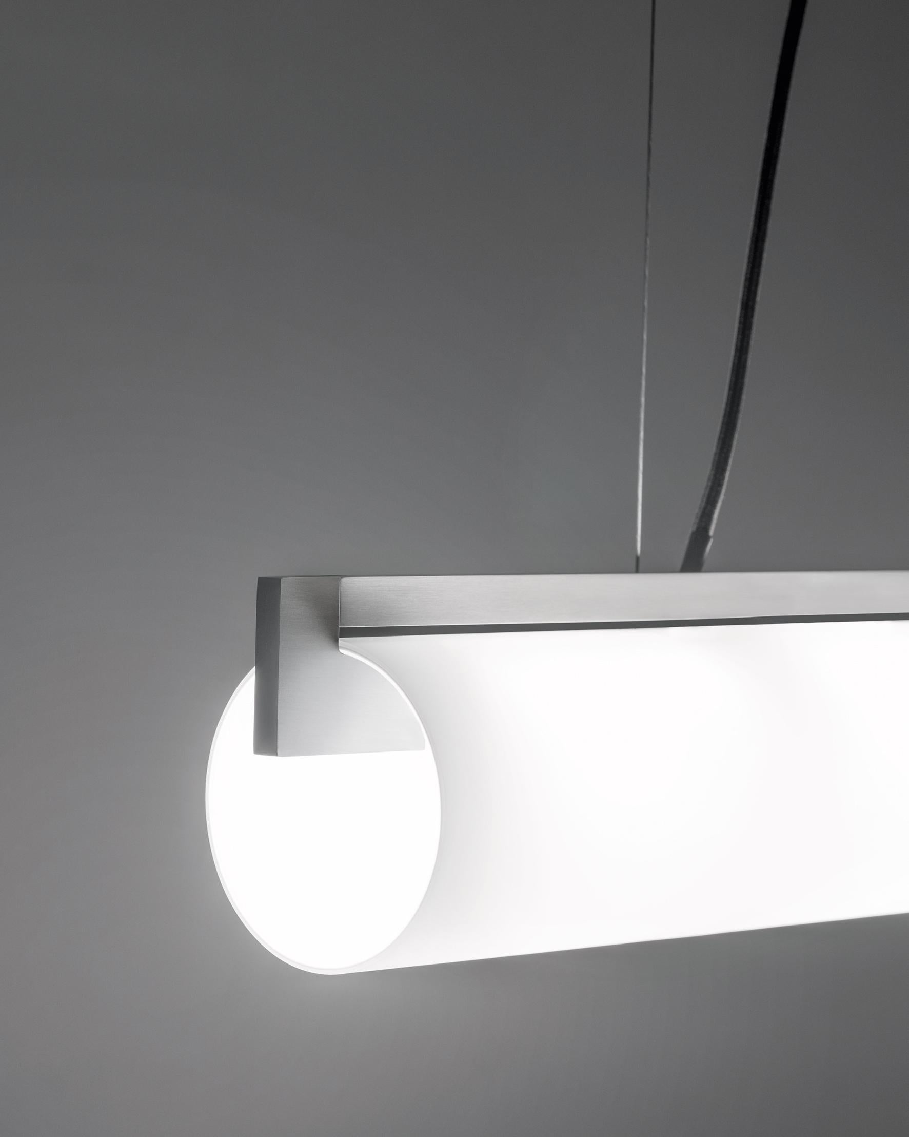Please note that VAT is not included in the price.

Lighting system composed of pendant and wall version, realized with the combination of the smoothness of a hand blown, satin glass and the stiffness of the aluminium bars. The two bars host 2 10W