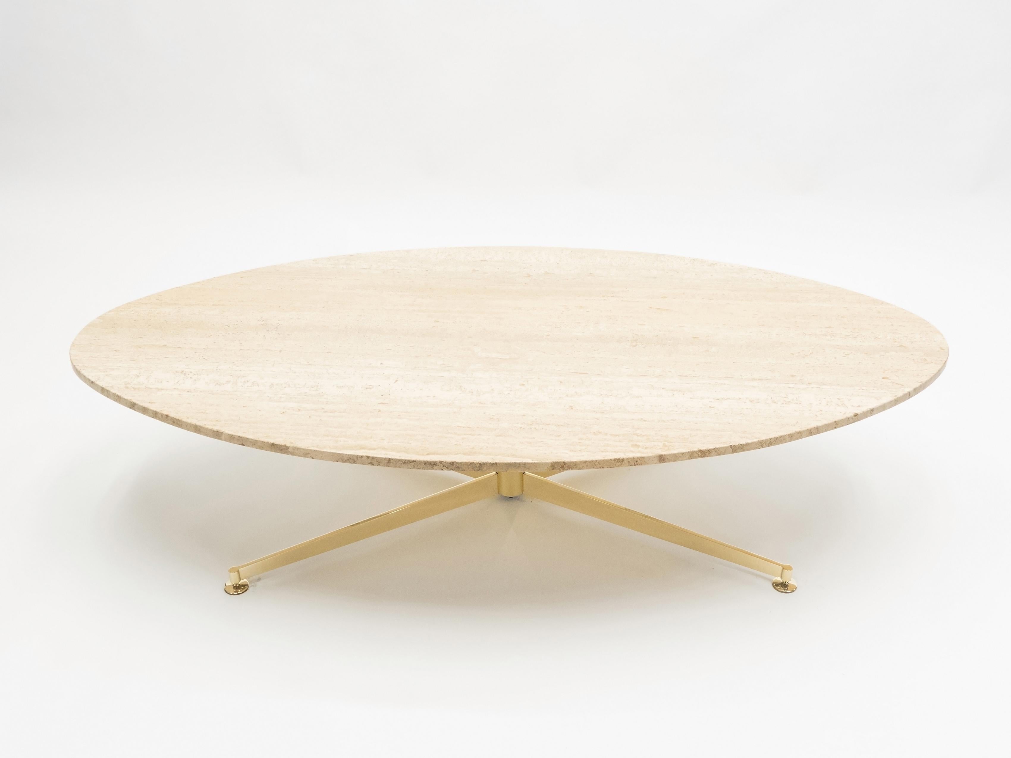 Extremely rare first edition elliptical coffee table by French designer Michel Kin for Arflex, Italy, from the early 1960s. The top is made of Italian travertine with an elliptical shape, supported by a brass pedestal with adjustable foot. The first