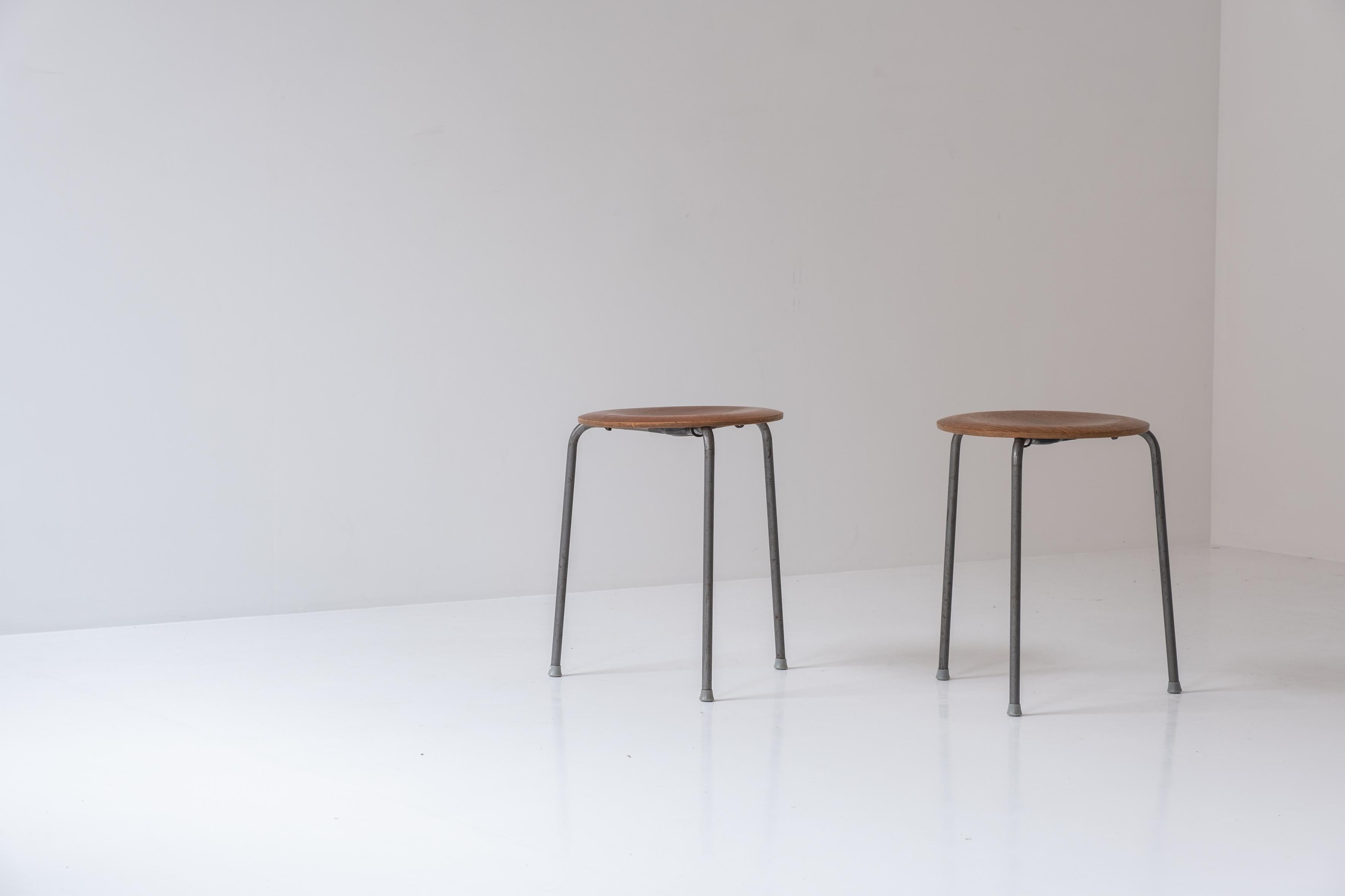 First edition pair ‘DOT’ stools by Arne Jacobsen for Fritz Hansen, Denmark 1960s. This three legged stool features nickel plated metal legs with teak seat top. Presented in its original condition. Could be restored upon request. Labeled underneath.