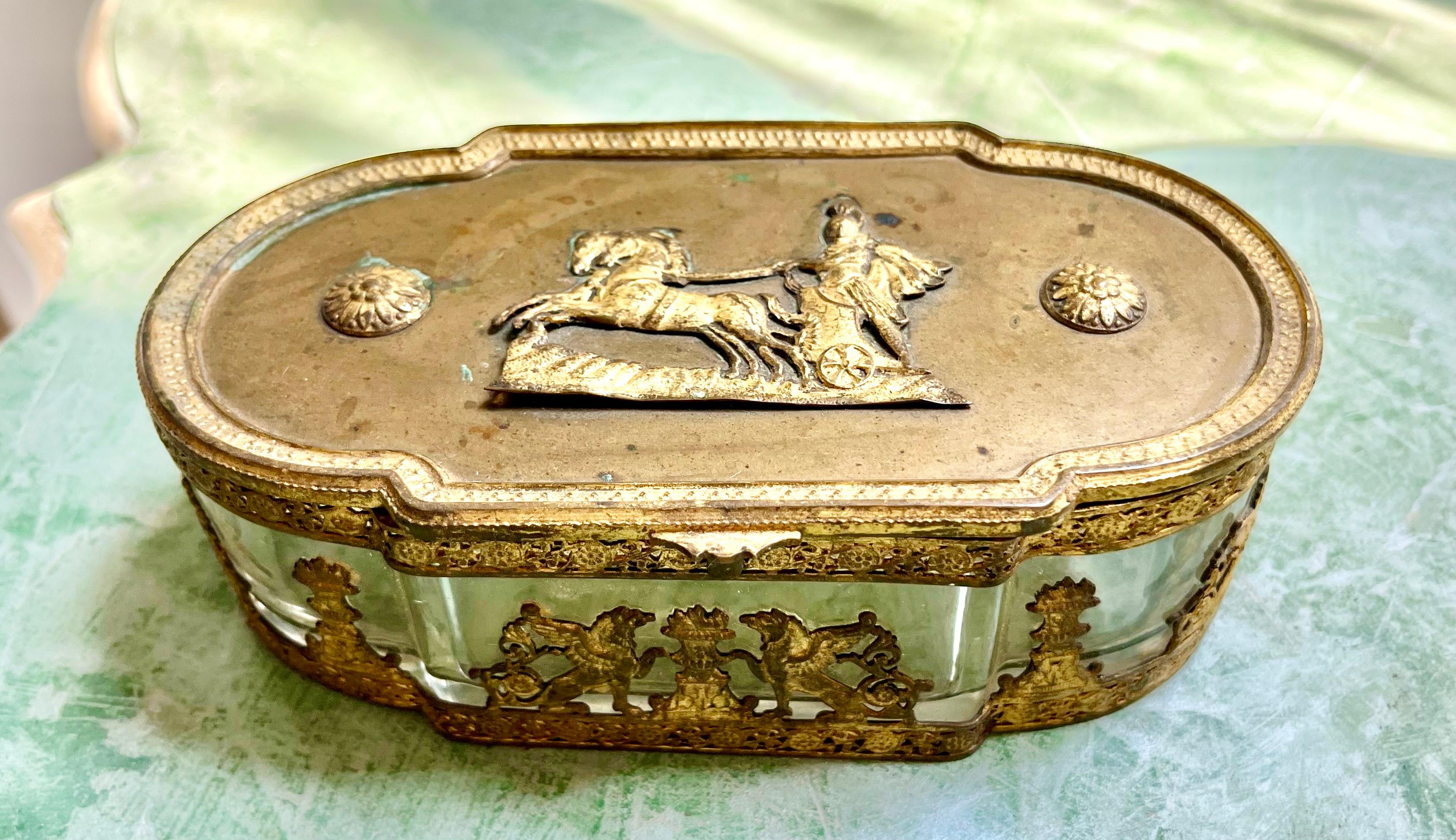 The box a trinket or bon-bon box , adorned with bronze lid and Apollo in his sunburst adorned chariot , the sides with griffins , floral urns .

Most likely and expensive gift or souvenir at the time of creation it is in original unaltered ,