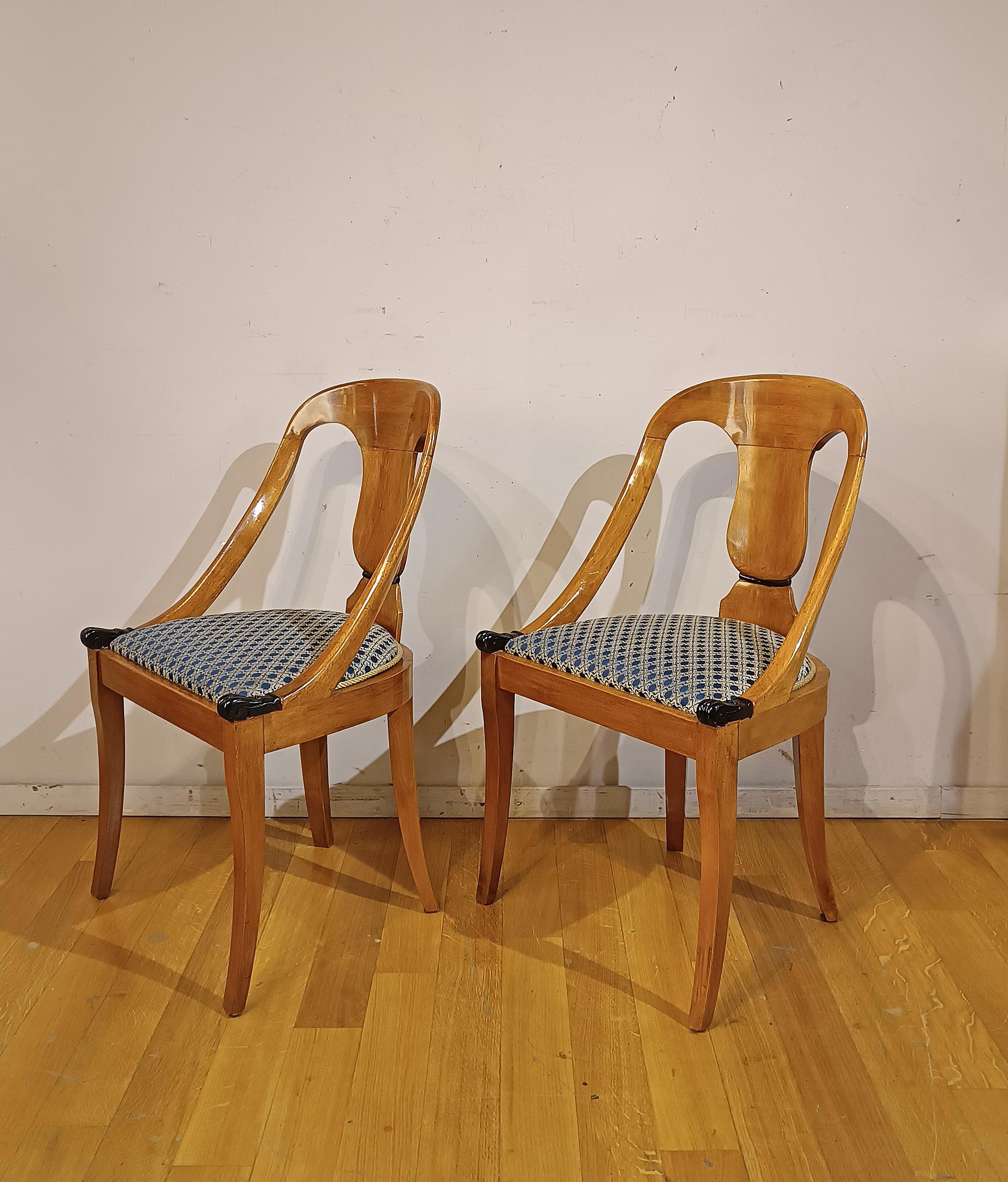 Beautiful pair of small armchairs in solid walnut. The backrest is tub-shaped, embellished with a drawn amphora and ebonized wood finishes. The armrests are also unique, ending with two feral paws also in ebonized wood. The legs are truncated