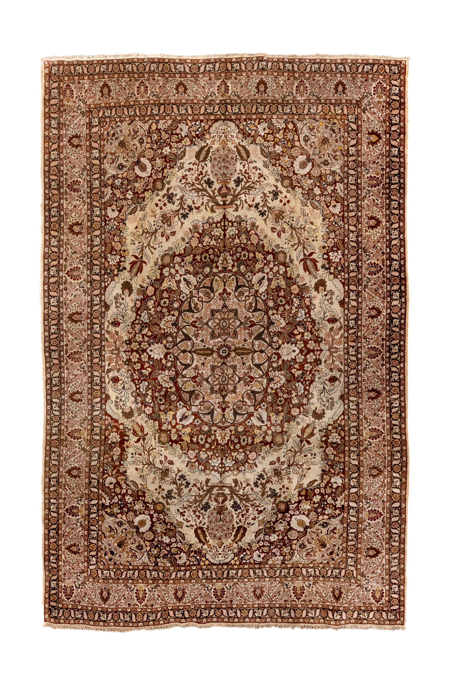 This Persian format NE Persian well woven city carpet shows a shaped cream field centred by a very expansive red medallion enclosing an elliptical sub-medallion edged with 12 radiating palmette pendants. Medallion pendants sit on trays. Red floral
