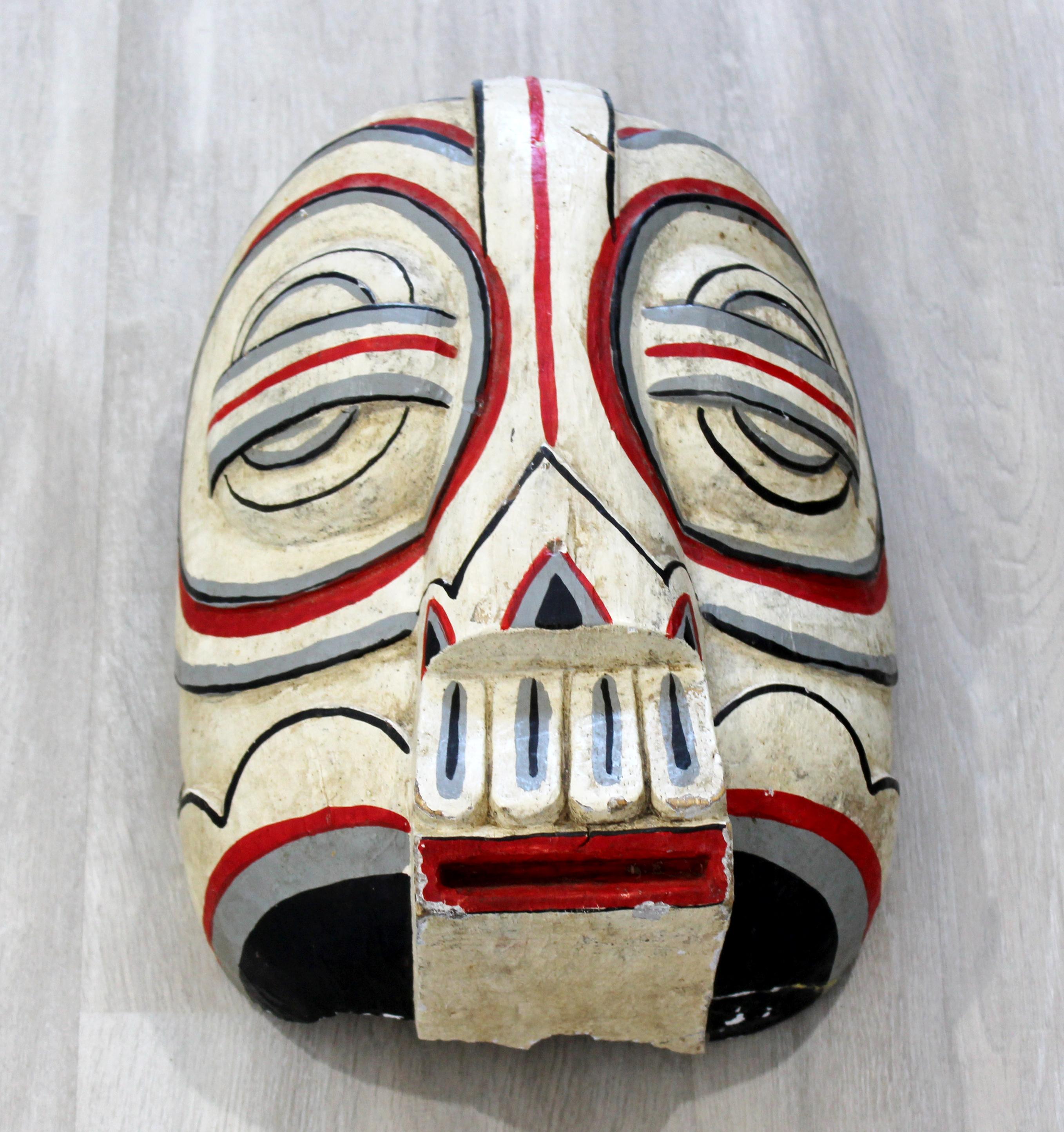For your consideration is a wonderful, carved and painted wood wall art sculpture, of a totem style, tribal mask. In fair condition, removed from foundation. The dimensions are 9.5