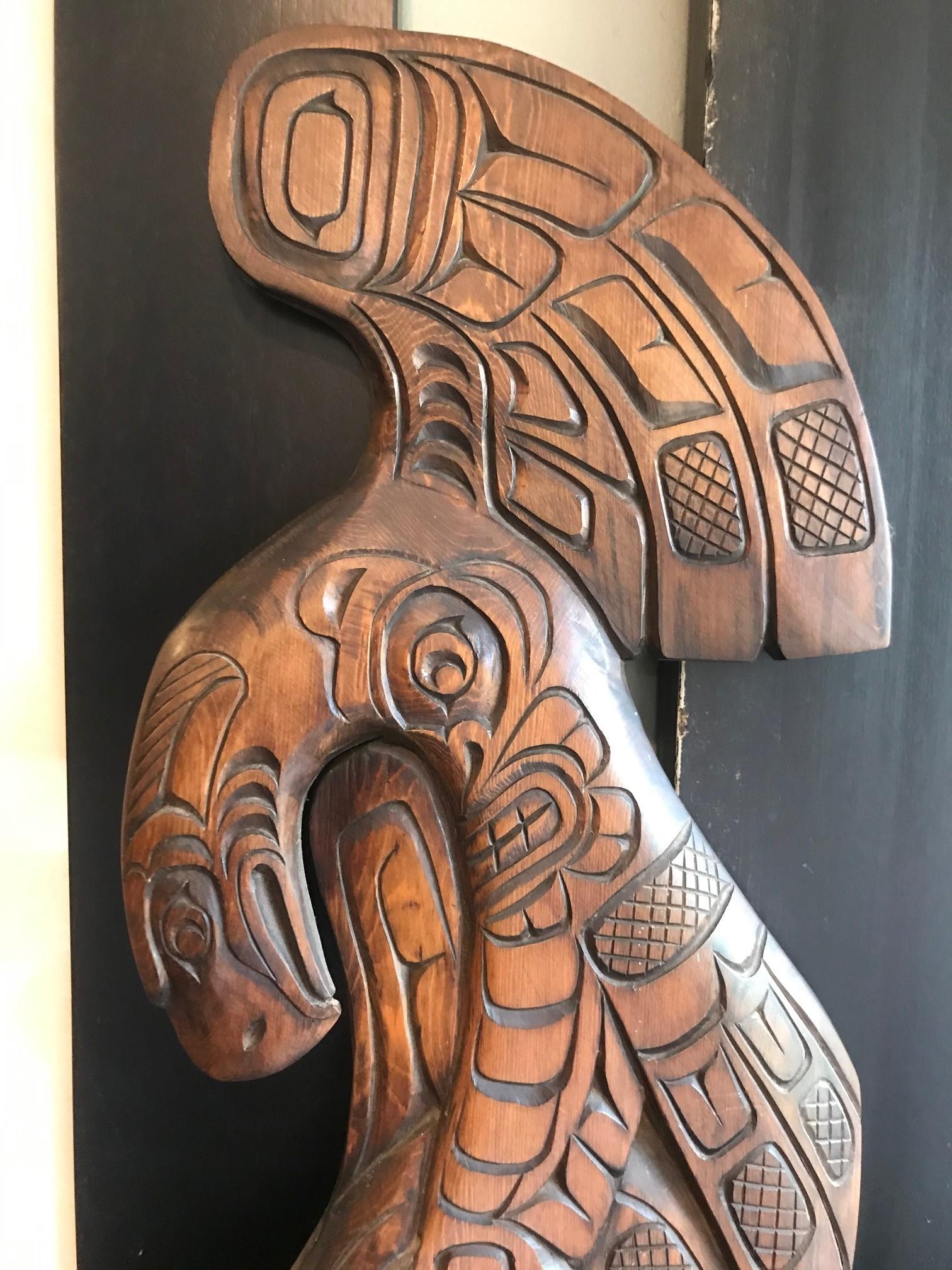 A wonderful example of true indigenous first nations Pacific Northwest Coast art by Robert (Bob) Whonnock. This carved wood panel shows an eagle and orca motif in exceptional detail. The wood has a lustrous, rich brown patina.

Robert Whonnock is
