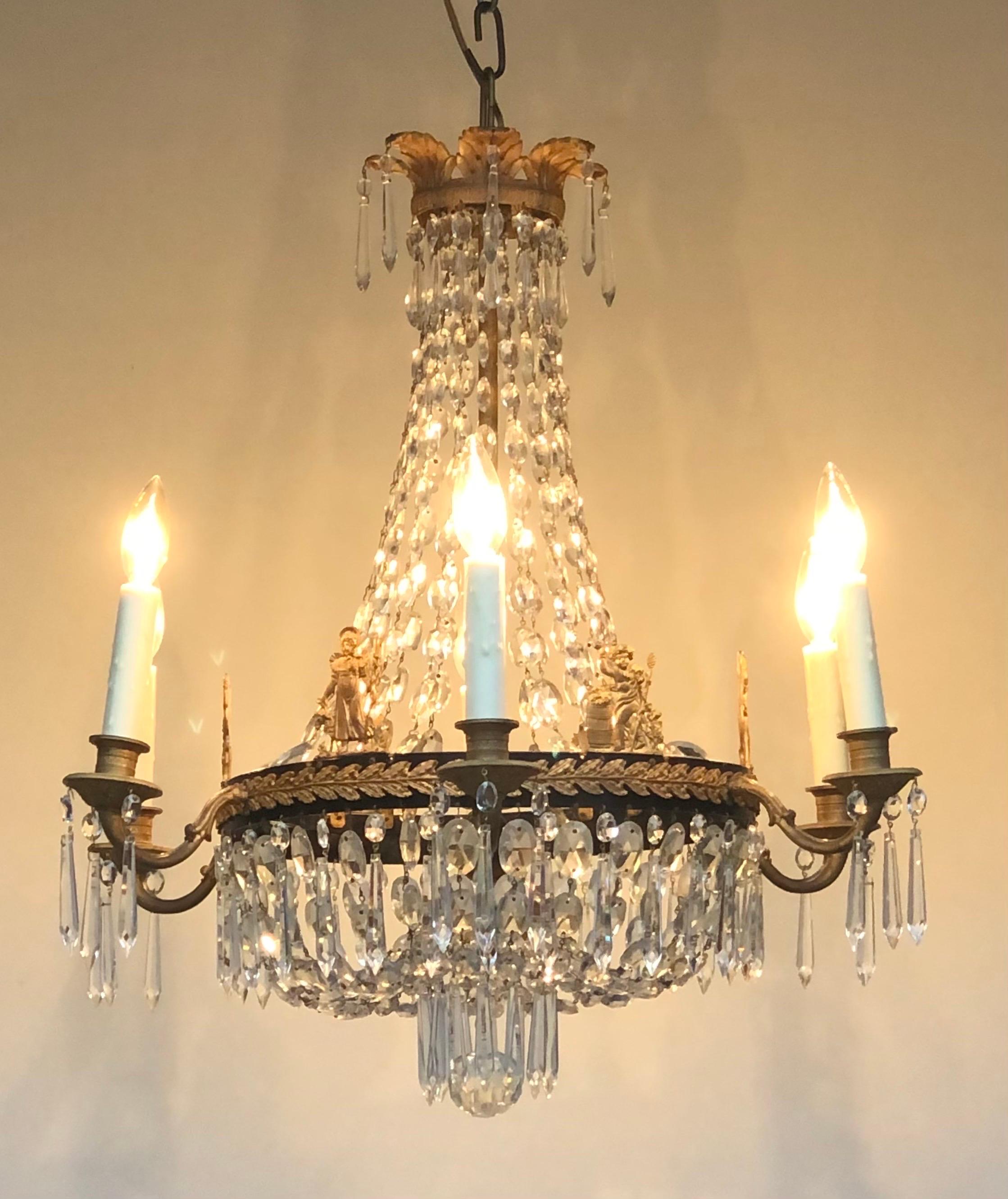  This Regal First Period French Empire Ormolu and Crystal Six-Arm Chandelier was made in France in the Early Nineteenth Century.  The Bronze Doré Castings are of the highest refined quality.  The Doré Corona is surmounted with seven Acanthus Leaves,