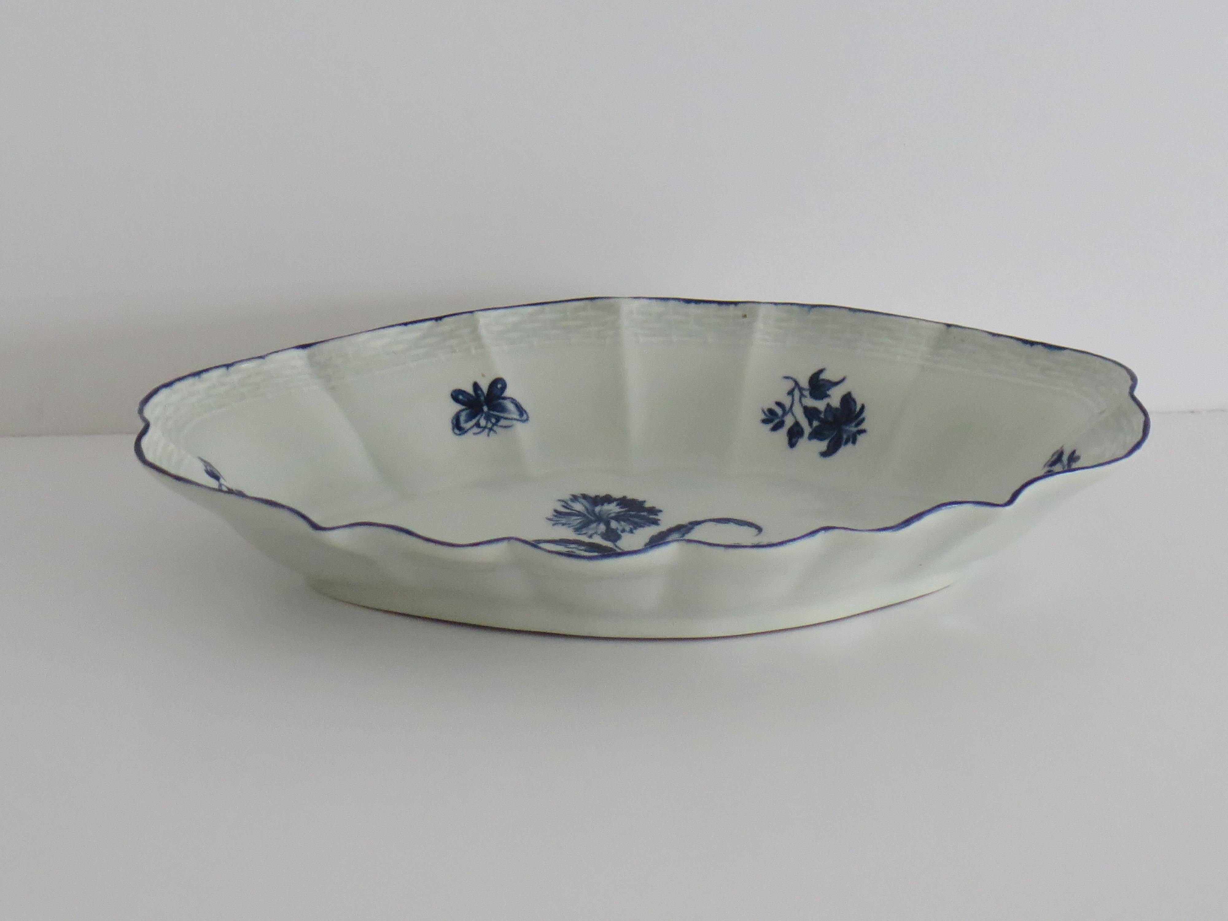 This is a very good early, First period (Dr. Wall), Worcester porcelain open Desert Dish in a deep cobalt blue floral pattern with a Crescent mark to the base. dating to 1765 to 1770.

This is a well potted moulded piece with a wavy edge and basket