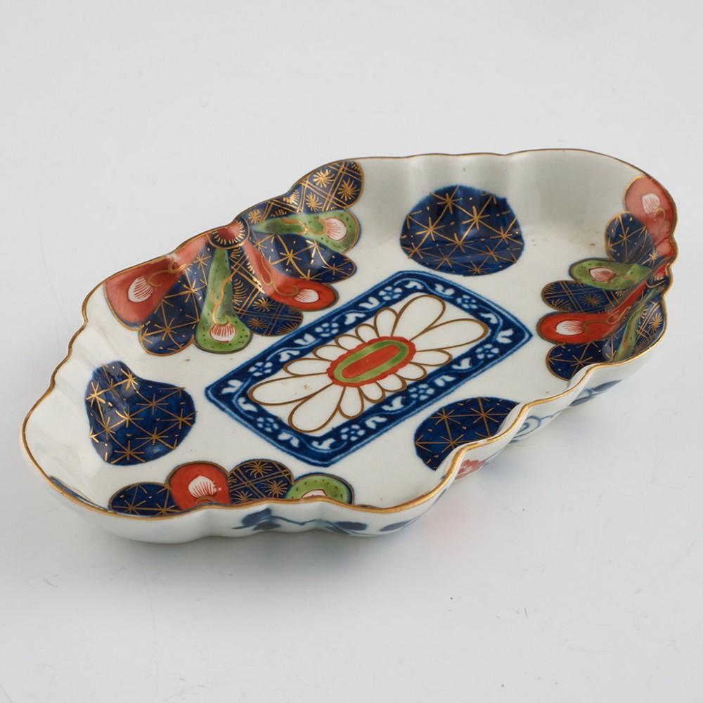 Heading :  First Period Worcester Japan Fan Pattern Spoon Tray
Date : c1770
Period : George III
Marks : Faux Chinese marks
Origin : Worcester
Colour : Imari palette
Pattern : Japan fan
Condition : Excellent
Restoration None
Dimensions : Length