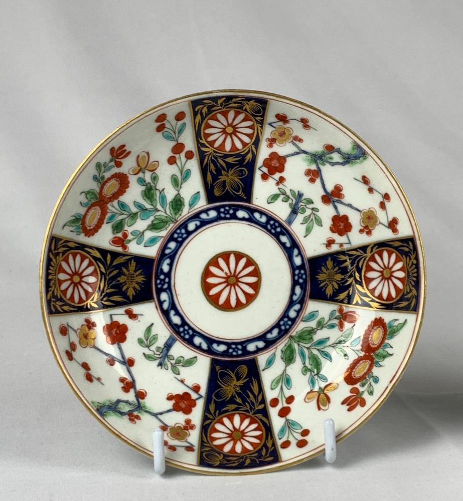 This First Period Worcester Porcelain cup and saucer are hand-painted in the beautiful Queen’s Pattern, which was inspired by Japanese Imari porcelain of the 17th century.
The design features four panels decorated with delicate Kakiemon-style
