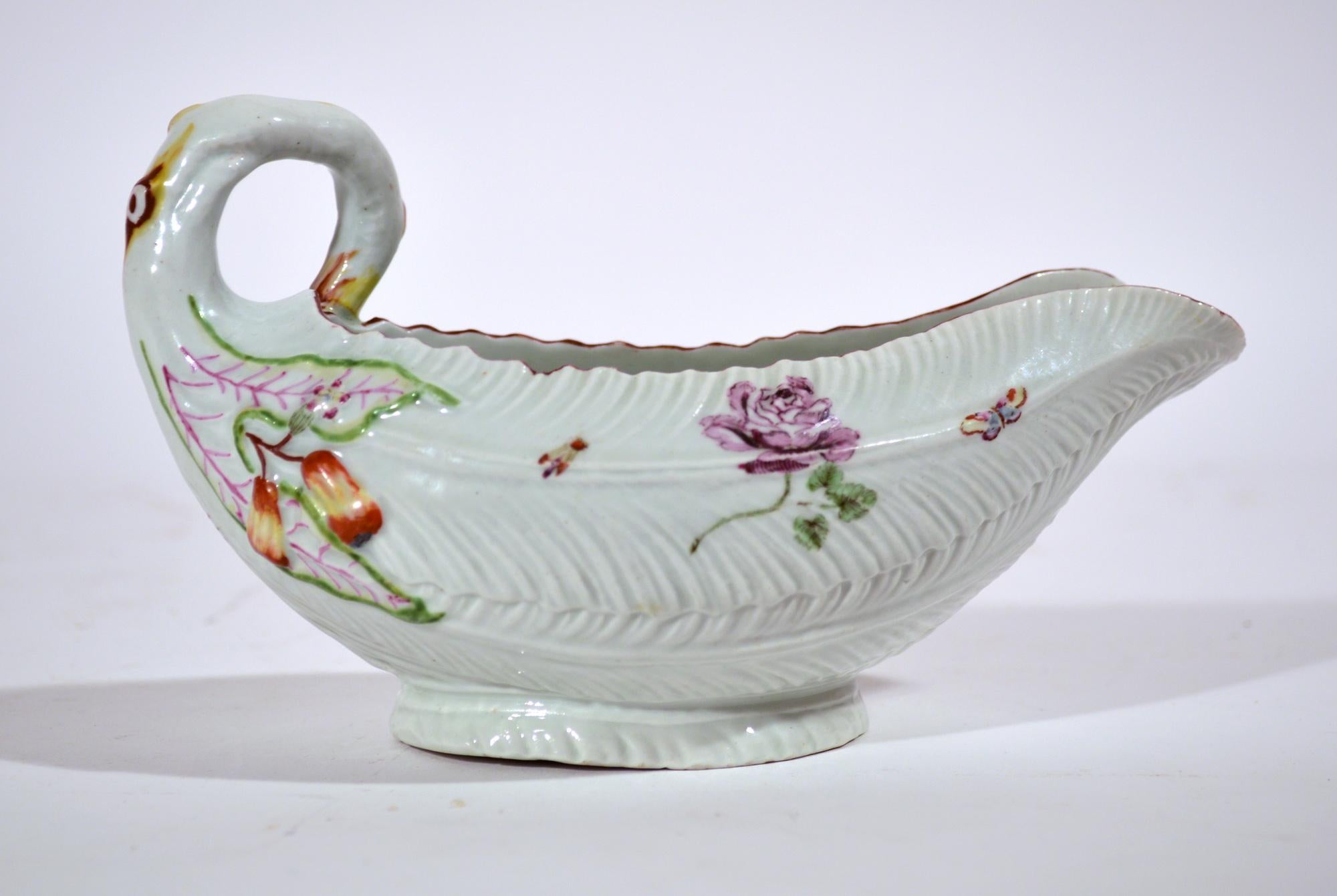 First Period Worcester porcelain leaf molded sauce boat, 
Circa 1755-56 

The early First Period Worcester porcelain sauce boat is modeled in the form of overlapping cos lettuce leaves. This form and decoration are based on Meissen porcelain form