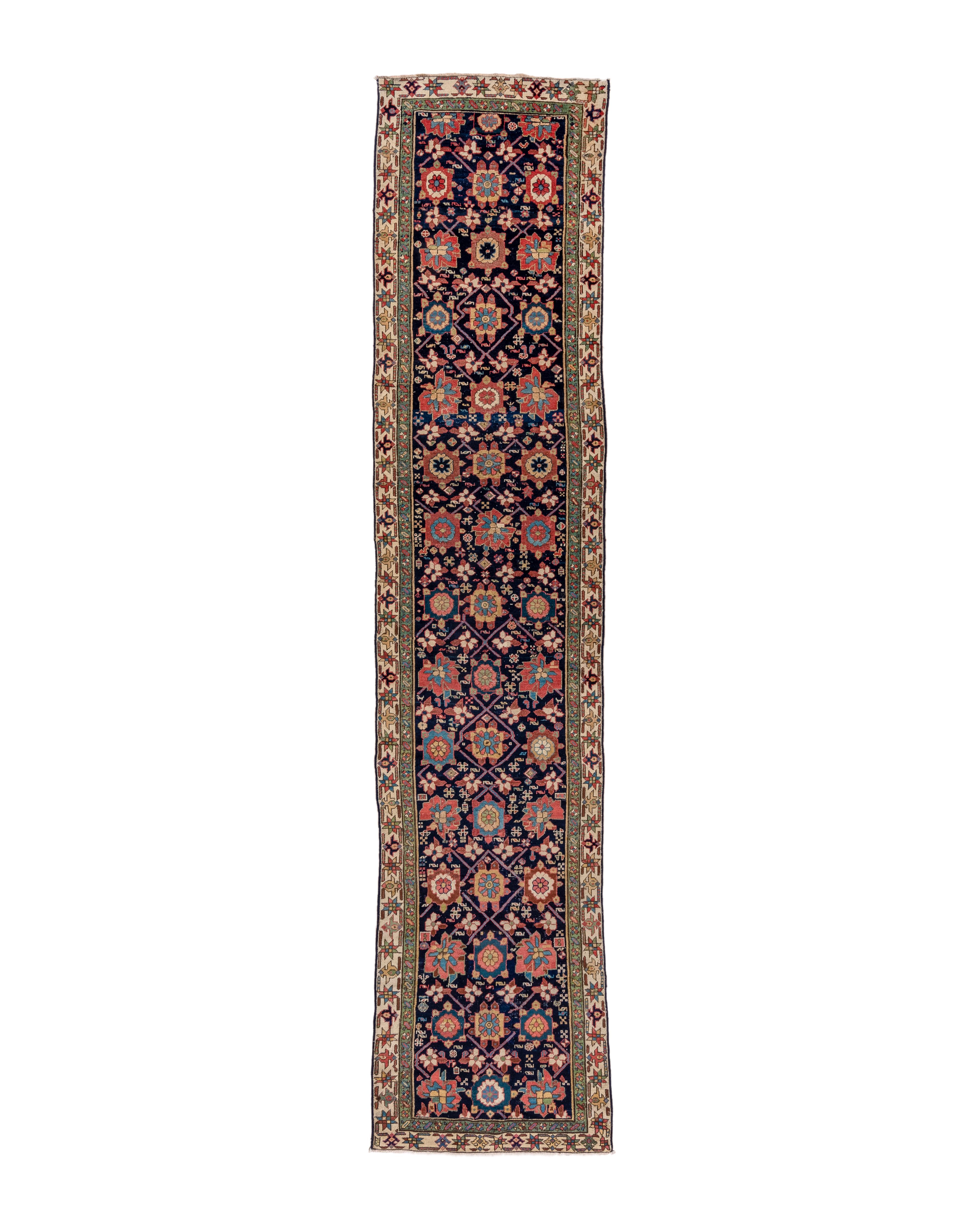 First quarter 20th century
This attractive, medium-weave piece from west-central Persia shows an elaborately developed Mina Khani design especially popular in this area. The navy field features a lozengoid lattice with two kinds of rosettes,,
