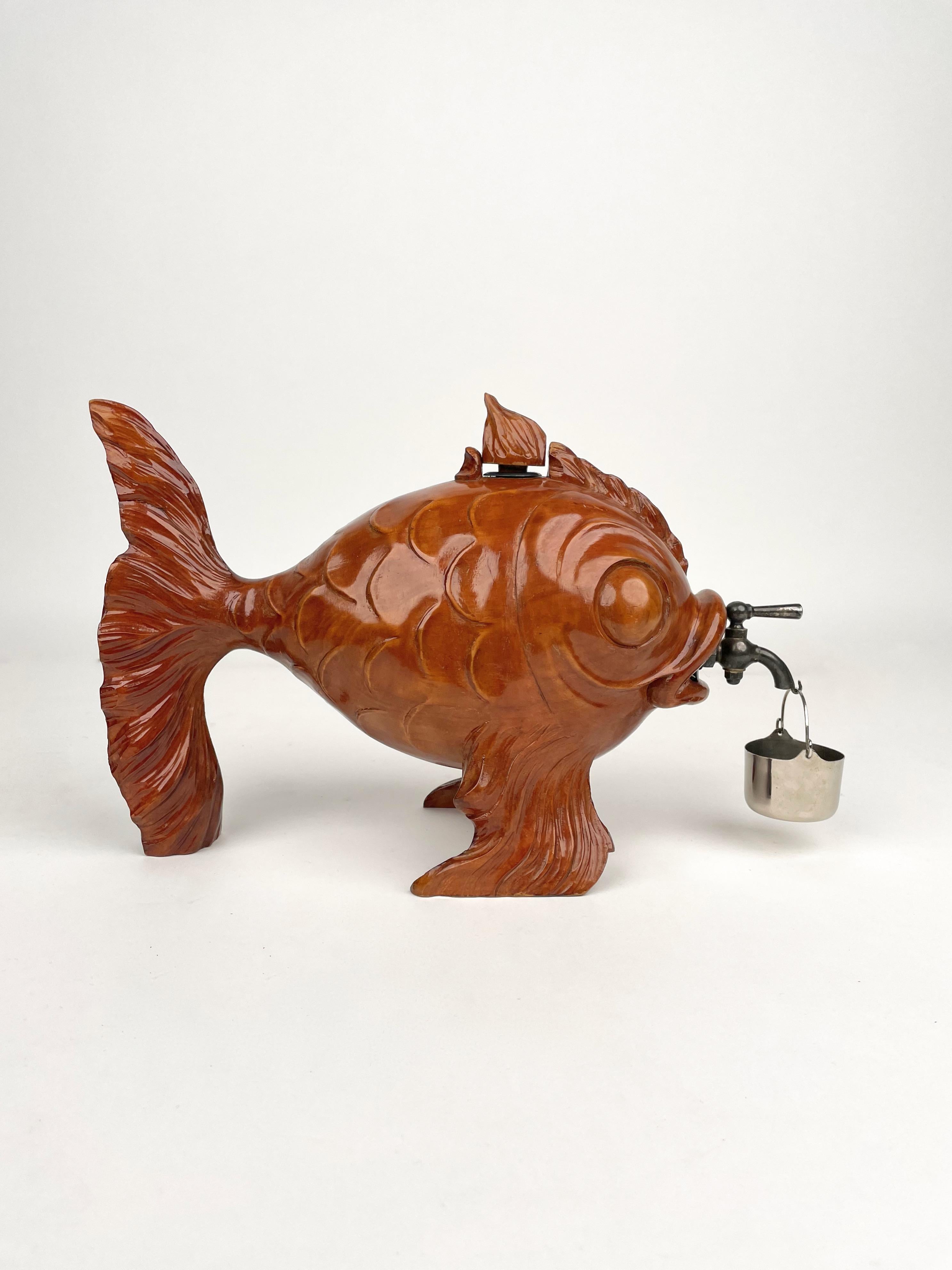 1950s fish shaped bottle dispenser in hand-carved wood featuring metal details by the Italian designer Aldo Tura for Macabo.