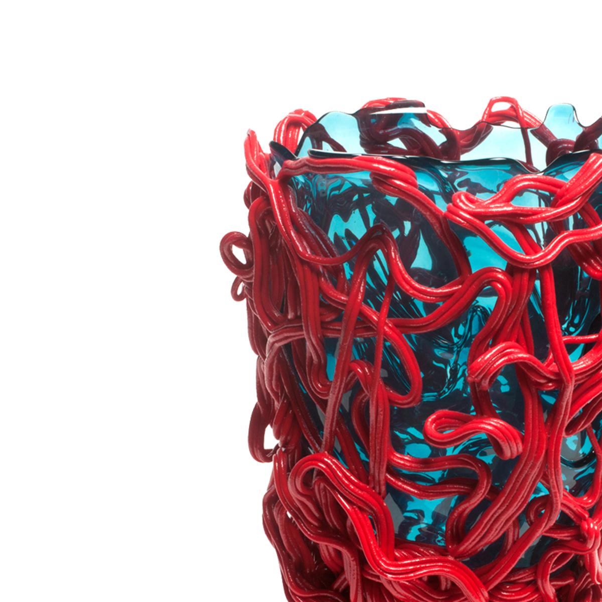 Spaghetti Special Vase - Clear aqua and coral red

Vase in soft resin designed by Gaetano Pesce in 1995 for Fish Design collection.

Measures: XL - ø 30cm x H 56cm

Other sizes available

Colours: Clear aqua, matt red.
Vase in soft resin designed by