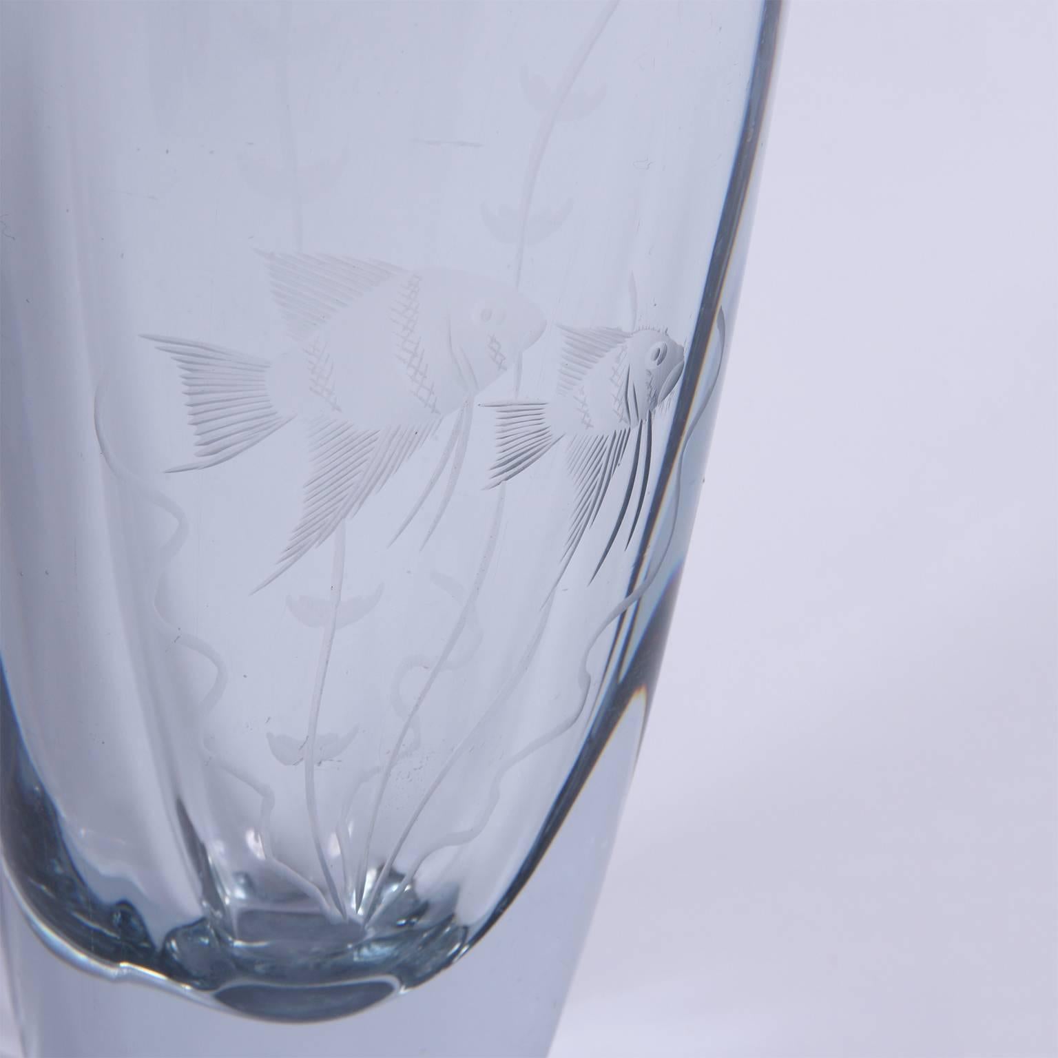 Heavy glass vase, it has deep etching with a detailed fish design.