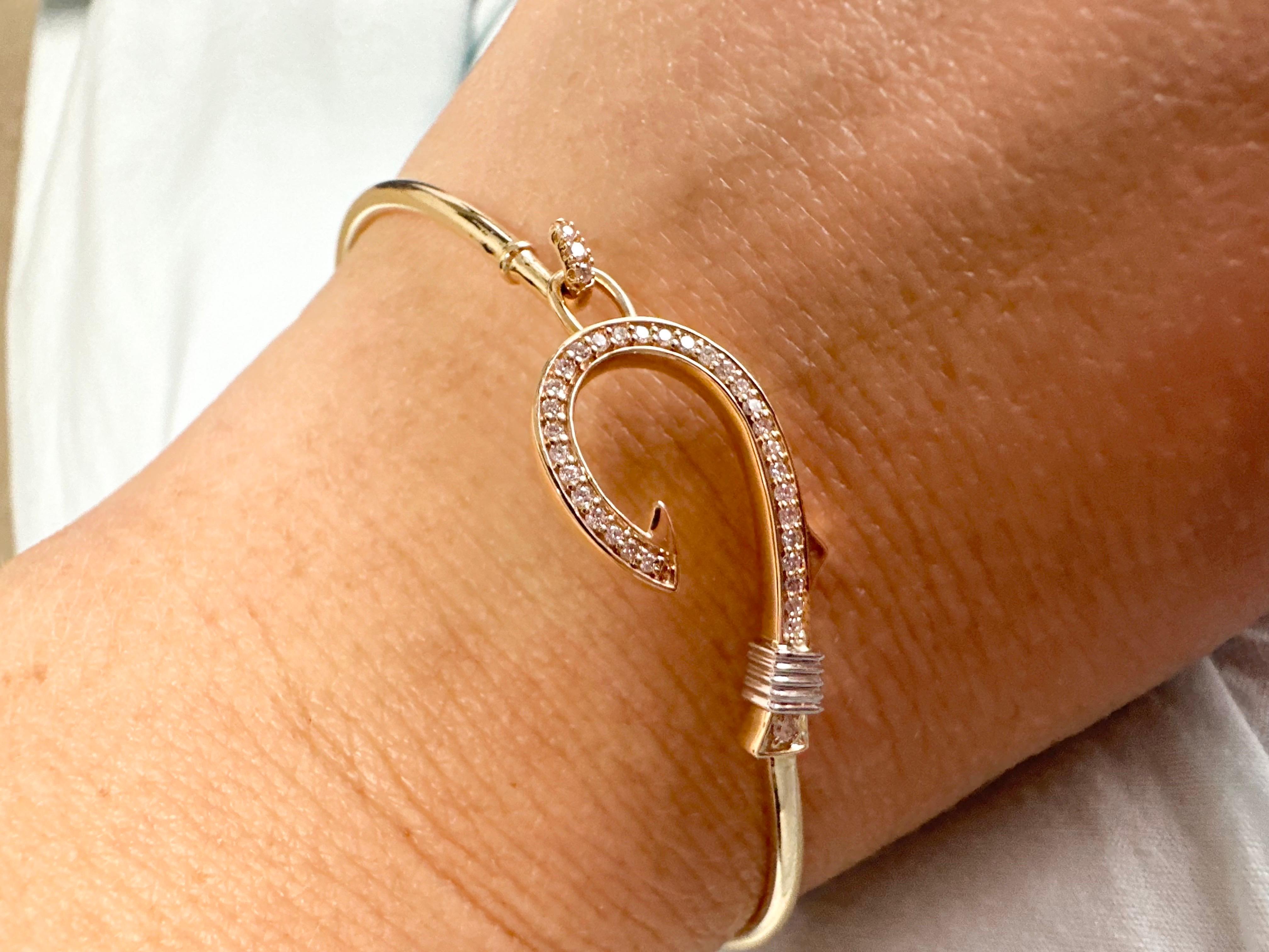 Fishhook bracelet with 0.18 carats of diamonds in 14KT gold, the bangle bracelet is flexible, comfortable and stunning when on your wrist! Certificate of authenticity comes with the purchase!

METAL: 14kt
NATURAL DIAMOND(S)
Clarity/Color: