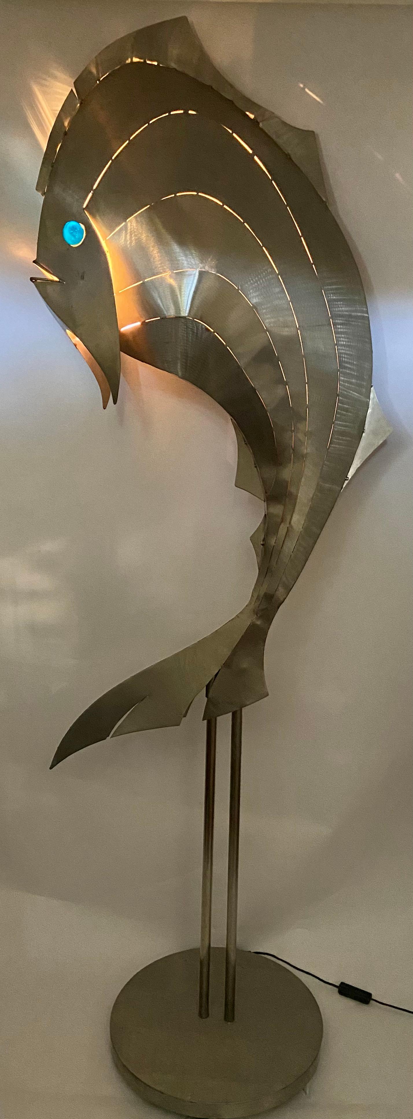 metal fish sculpture on stand