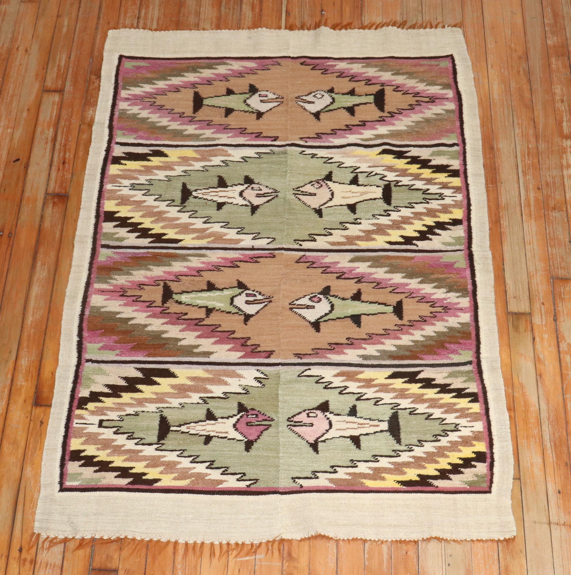 A vintage Peruvian flat-woven textile with a stylized fish design, circa 1940. This is a flat-weave and hand woven with wool, but with no upward pile. In very good condition. It can be used as a floor covering, or as wall decor. 

Measures: 3'4