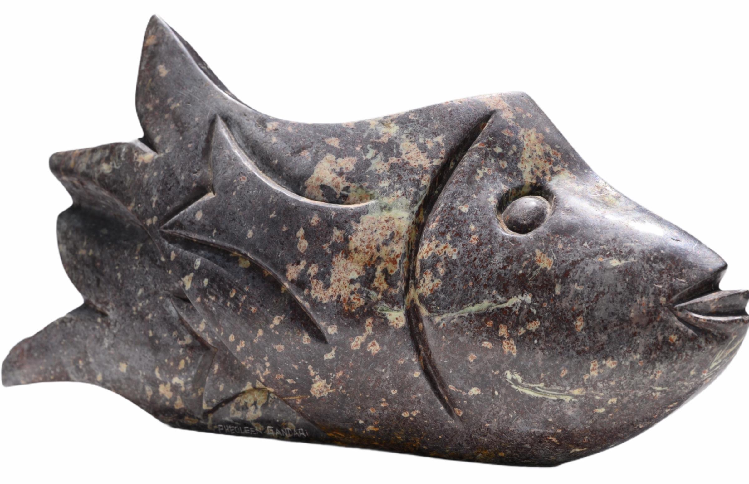 Beautiful and very decorative fish sculpture hand-carved from shona stone. 
Signed by the artist Pheoleen Gandari who is from Zimbabwe.

This wonderful sculpture measures 19 1/2