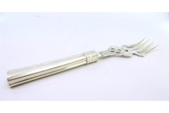 Fish serving fork in cut silver with engravings and grooves on the handle