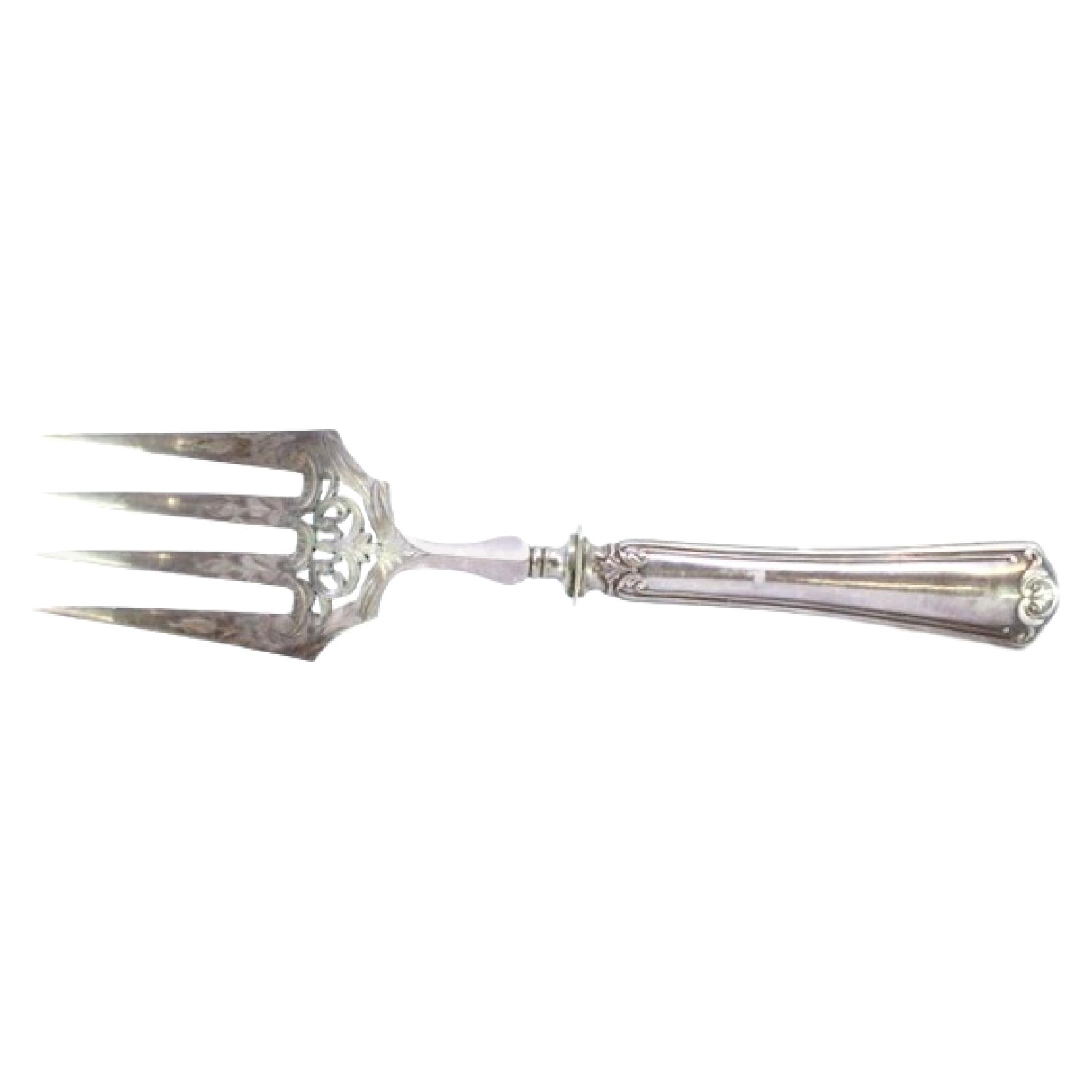 Fish serving fork in cut silver with grooves along the handle and four prongs