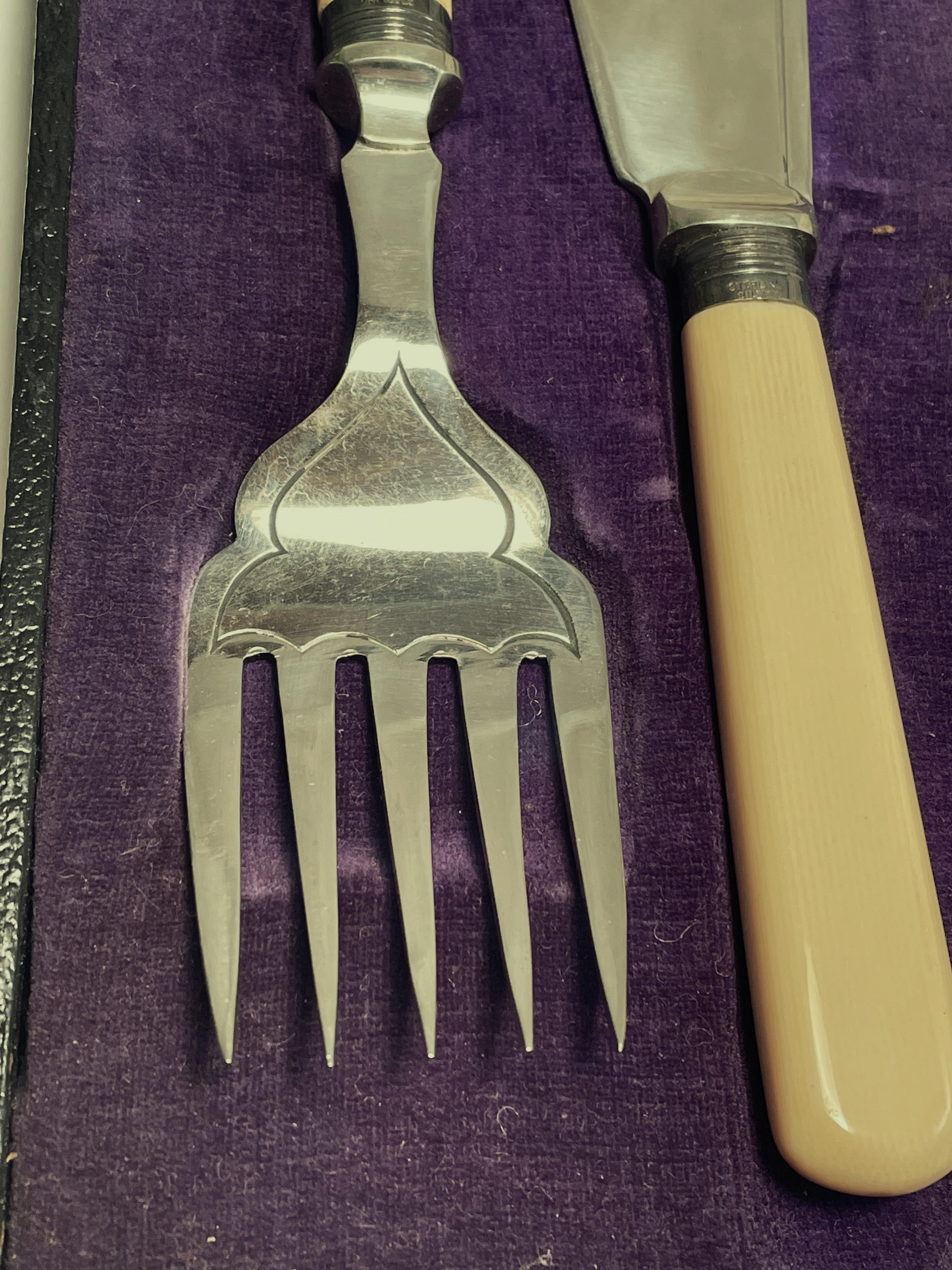 Here is an elegant fish serving knife and fork set with celluloid (early plastic) handles, a sterling silver band on each piece (which I have not polished) and stainless steel knife blade and fork. The set is in nice condition in the original box