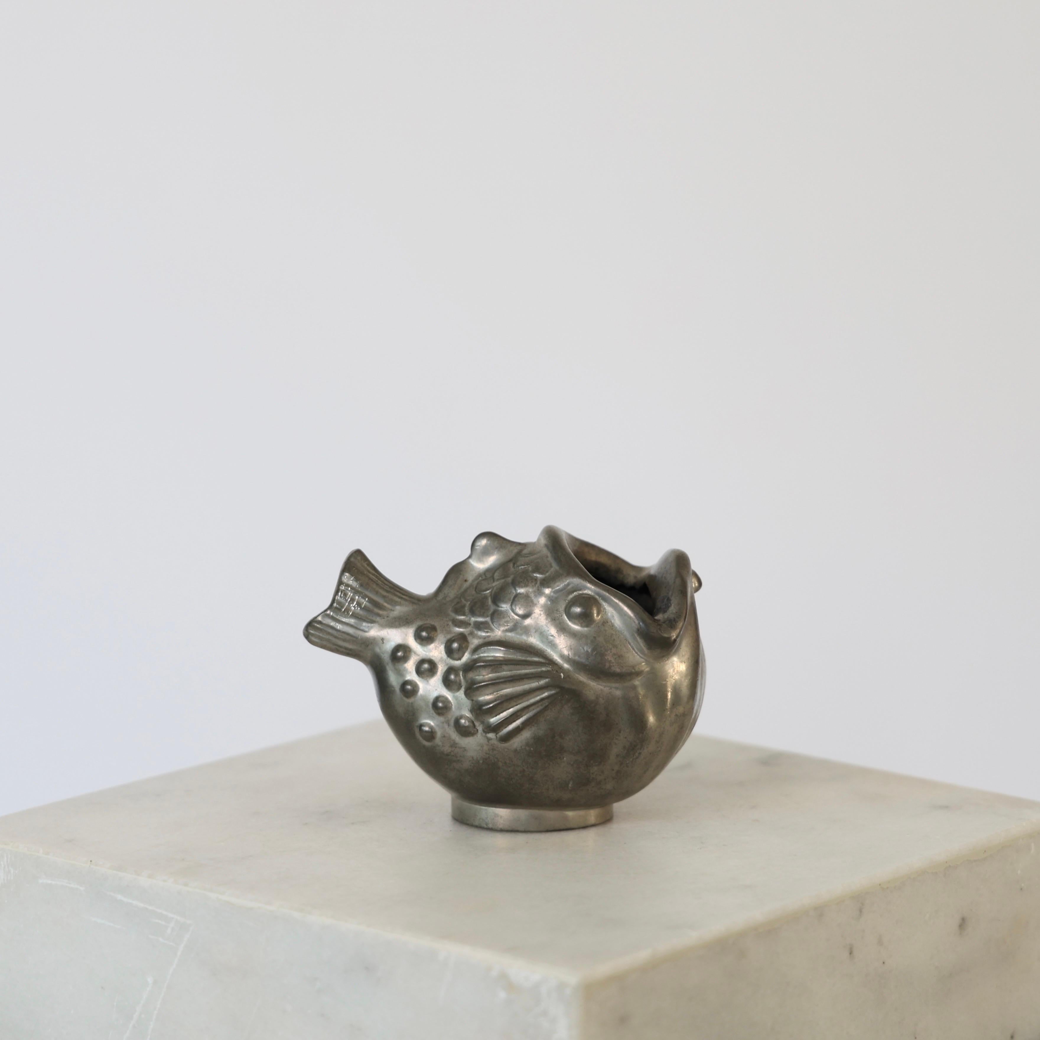 Fish-shaped Pewter Vase designed by Just Andersen in the early 1930s. 

* Fish-shaped pewter vase
* Designer: Just Andersen
* Model: 1389
* Year: 1929-1933
* Condition: Good vintage condition. Makers engraving intact. Few small marks and scratches,