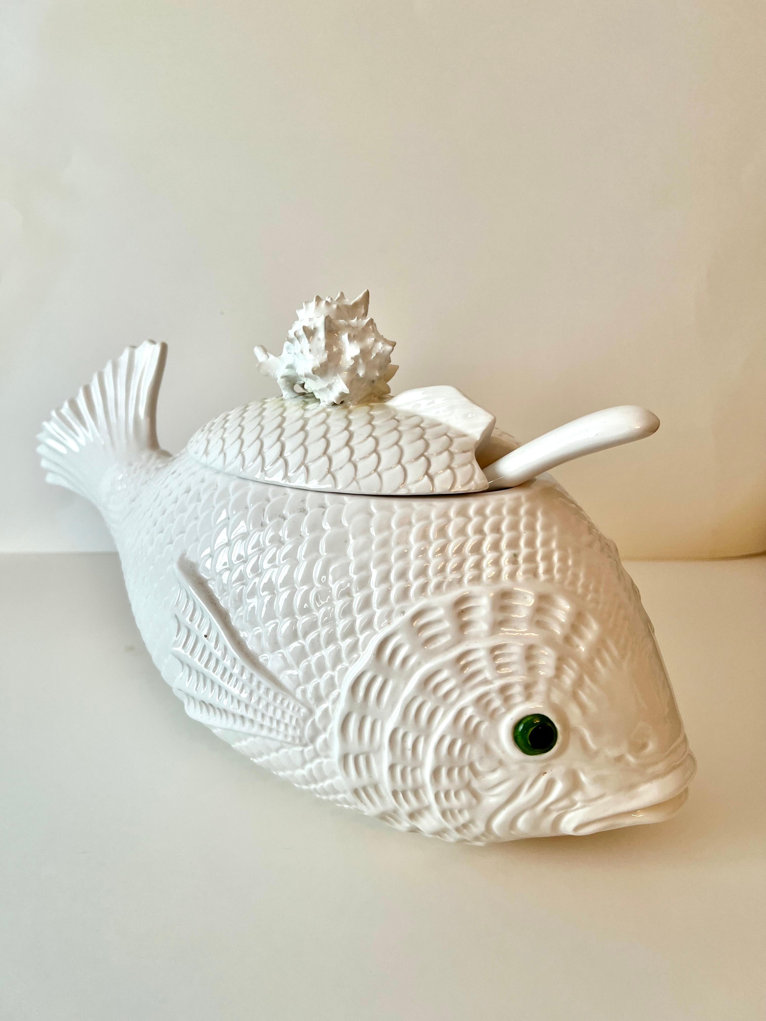 A unique soup tureen by Fitz and Floyd in the shape of a fish.. nice attention to details of scales, fins and eyes.. with a newly added shell lid opener that matches perfectly. All pieces in good condition with no chips or cracks.

The Tureen is