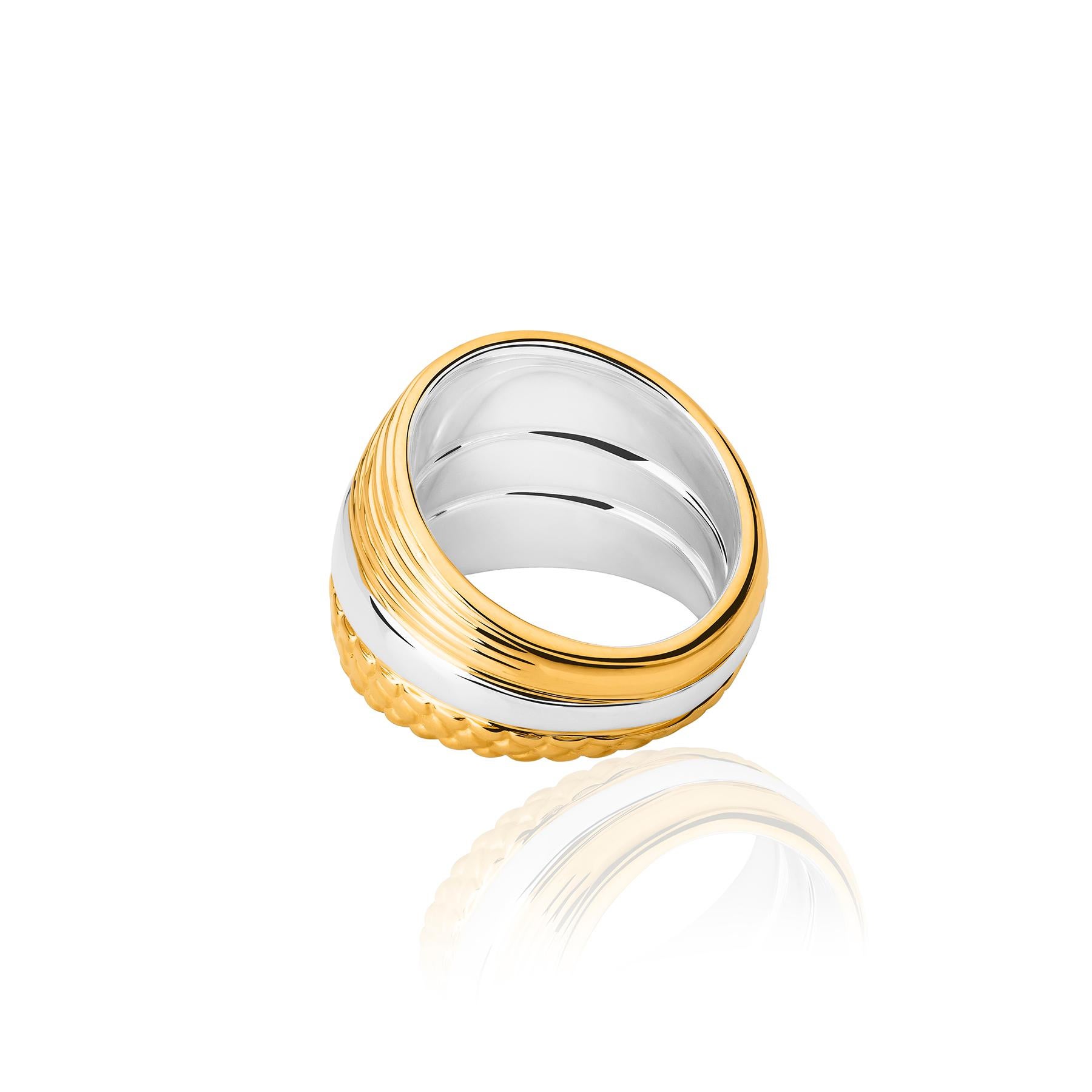 The Fish Textures Ring from the Animales Collection by TANE is made of sterling silver with 23 karat  yellow gold vermeil. It is made up of three linked rings. The central area of polished silver contrasts with the adjacent ones, delicately