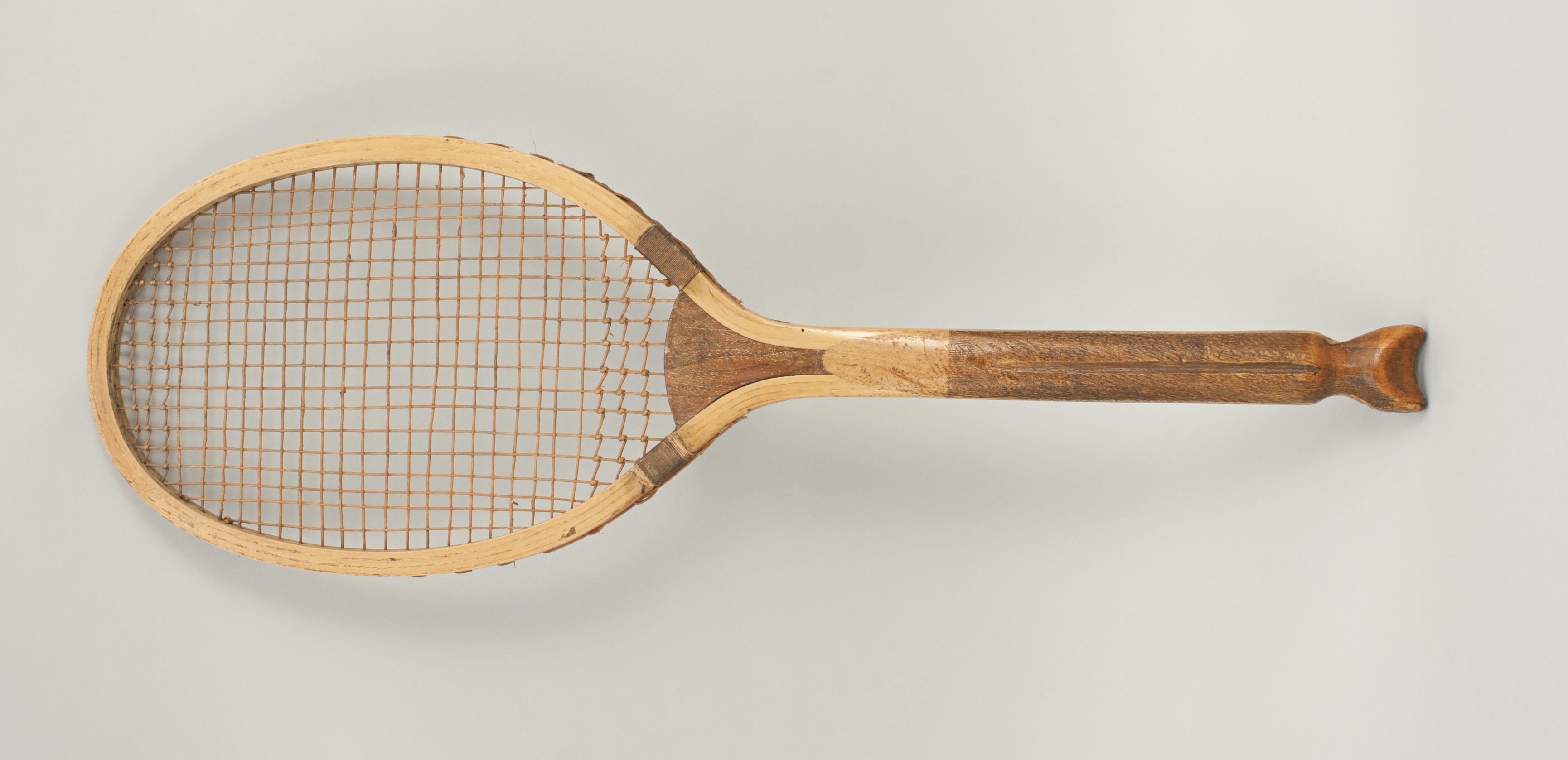 Vintage fish tail lawn tennis racket.
A Fine example of a wooden framed lawn tennis racket with nice clean ash frame and a walnut convex wedge. It has a good straight frame with a nice shaped fishtail handle, the handle with a deep central groove