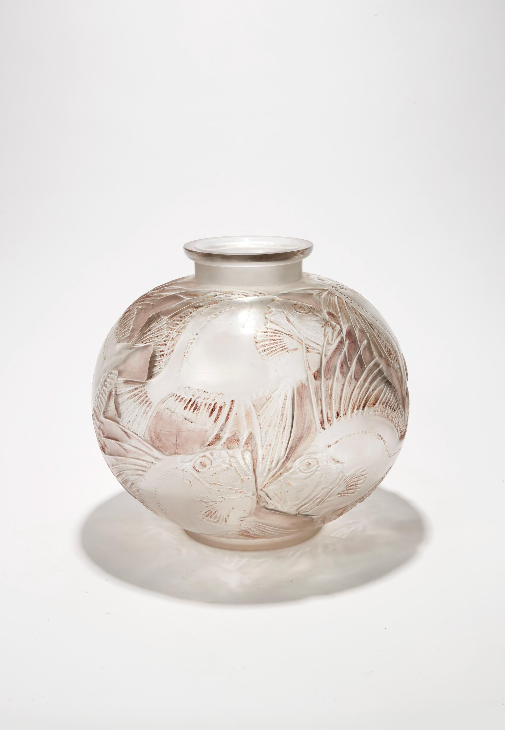 In white blown and moulded opalescent glass, the decor made
up with geometrical fishes. Signed.