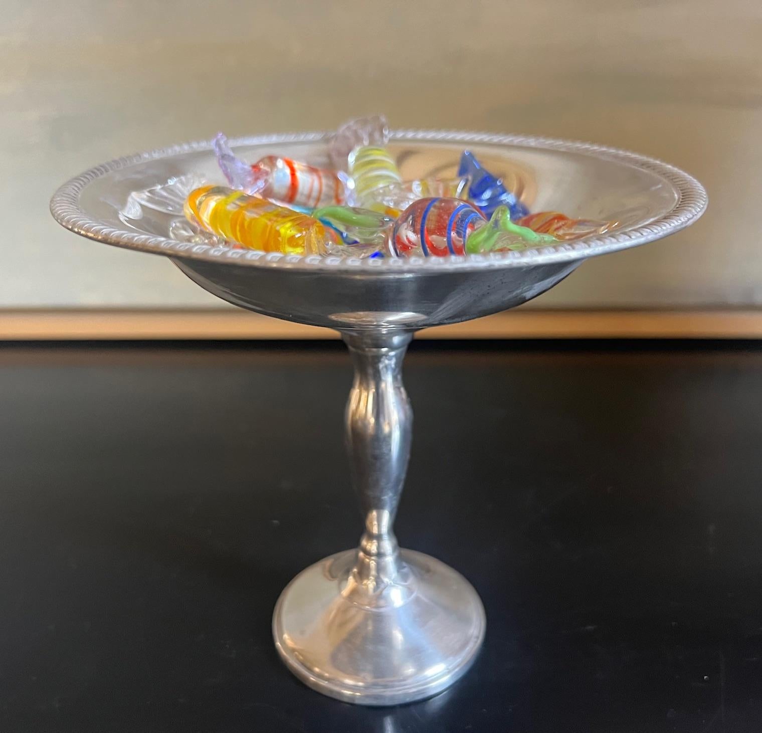 Sterling silver weighted pedestal candy dish made by Fisher in the 1970's. The dish is filled with twelve vintage blown glass candies.