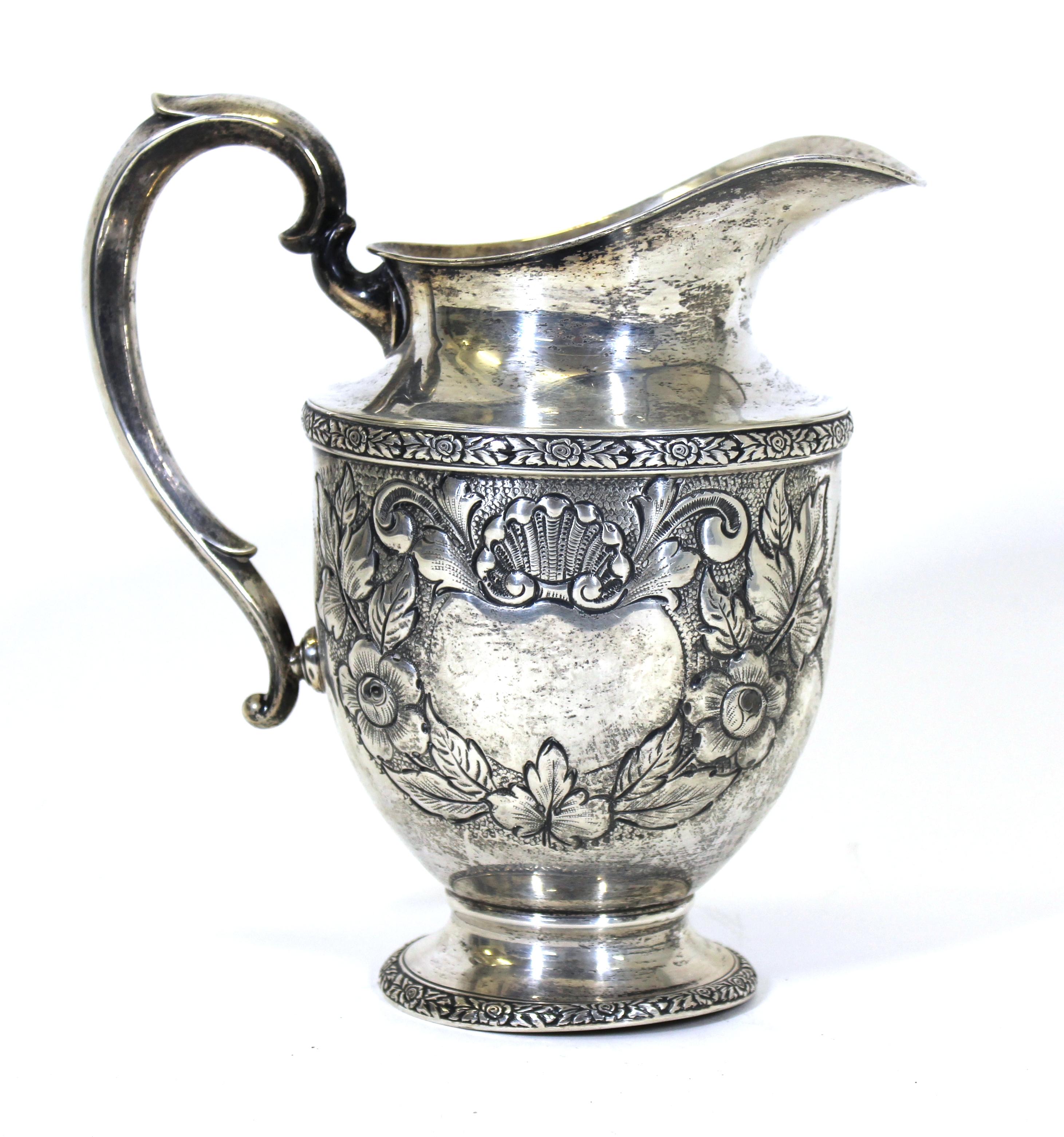 Fisher sterling silver pitcher with 'Rose Bouquet' motif, hand chased. Mark on the bottom.