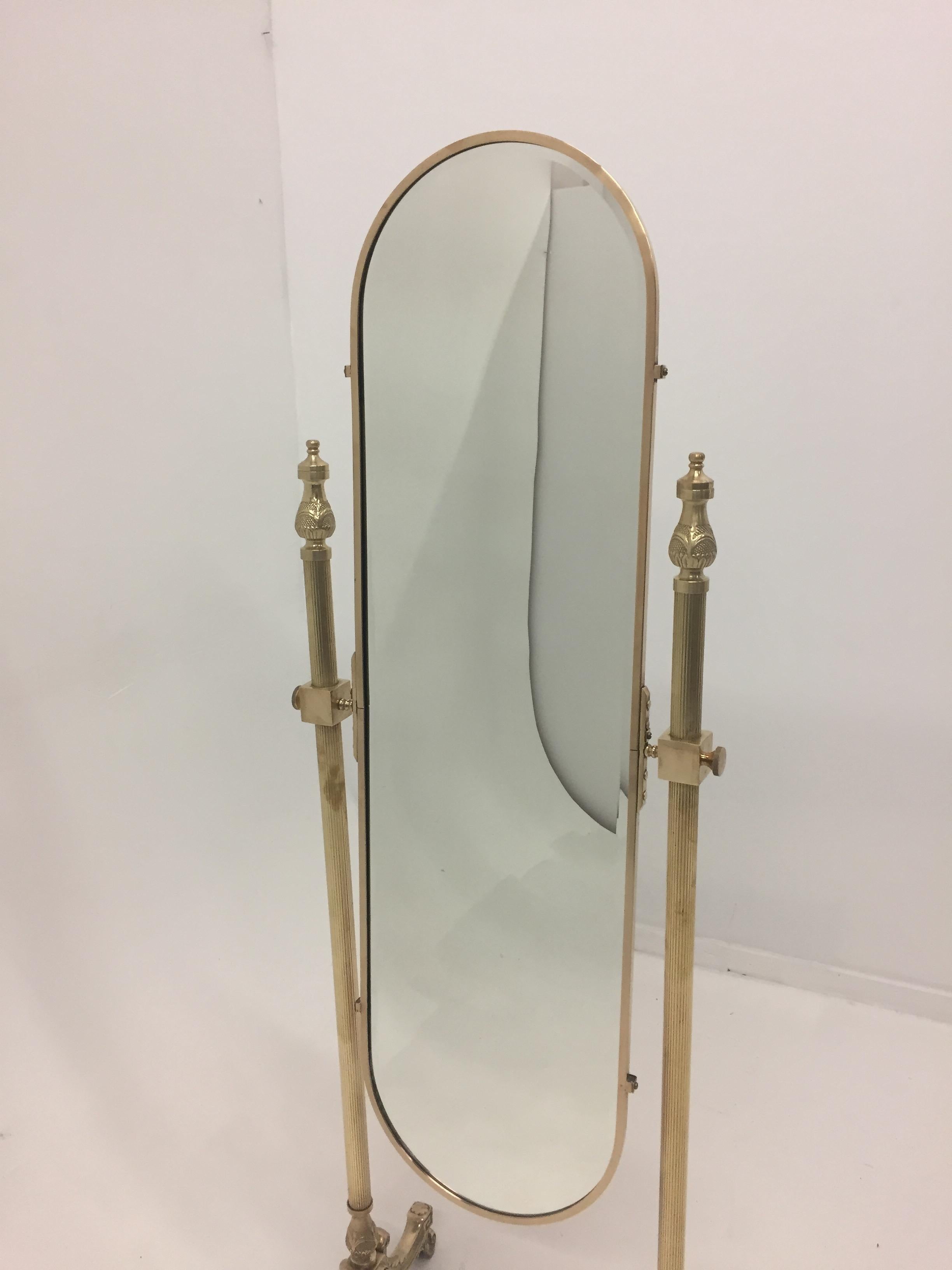 A very pretty Brass Recoco Chaval mirror having ornate feet and lovely oval full length mirror. Was just professionally polished to a gorgeous patina.