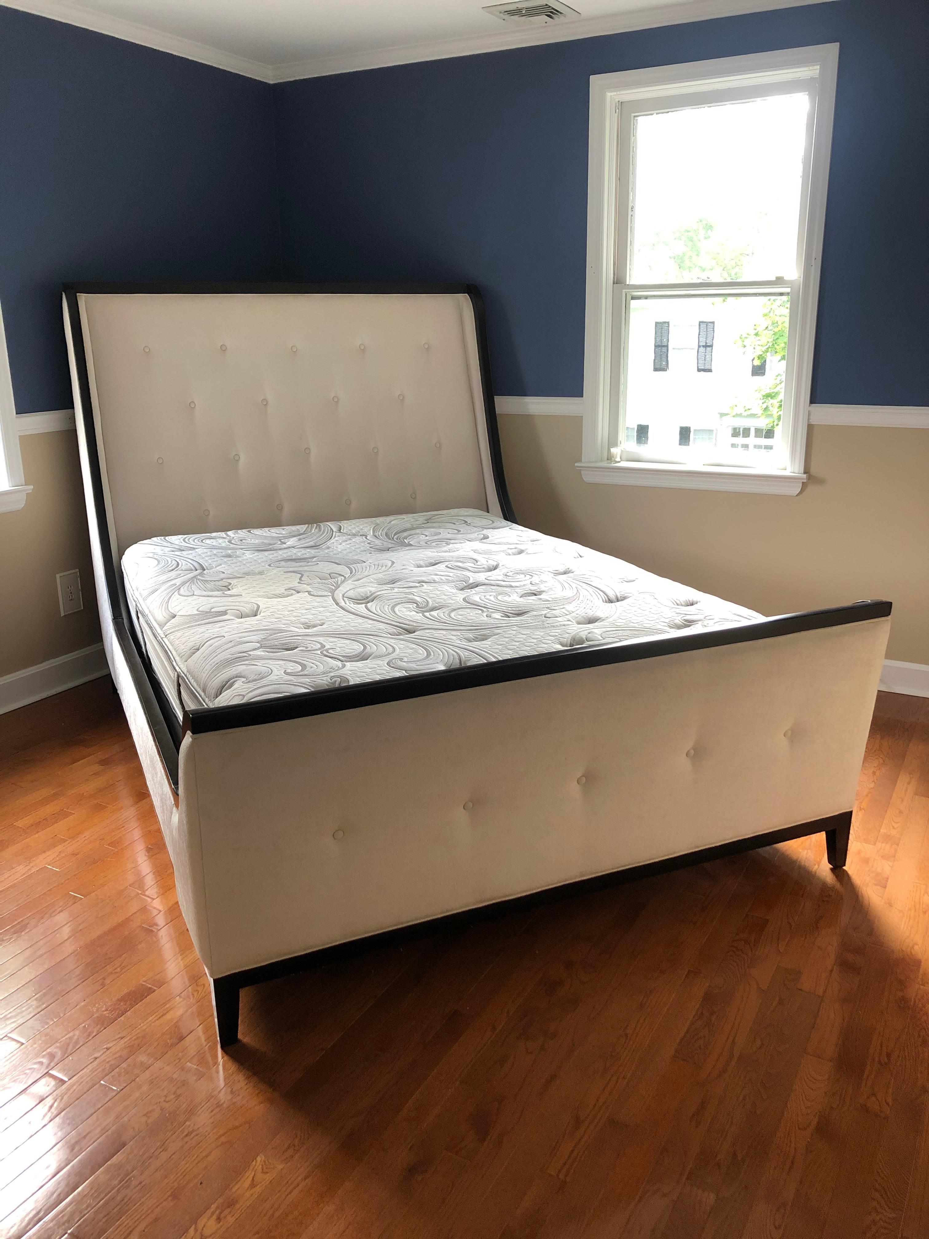 A super luxurious queen size sleigh bed fit for a Queen! Bed frame is upholstered in a cream plush chenille on headboard, footboard and side rails. The wood is ebonized and makes a gorgeous contrast to the upholstery.
Comes with box spring;