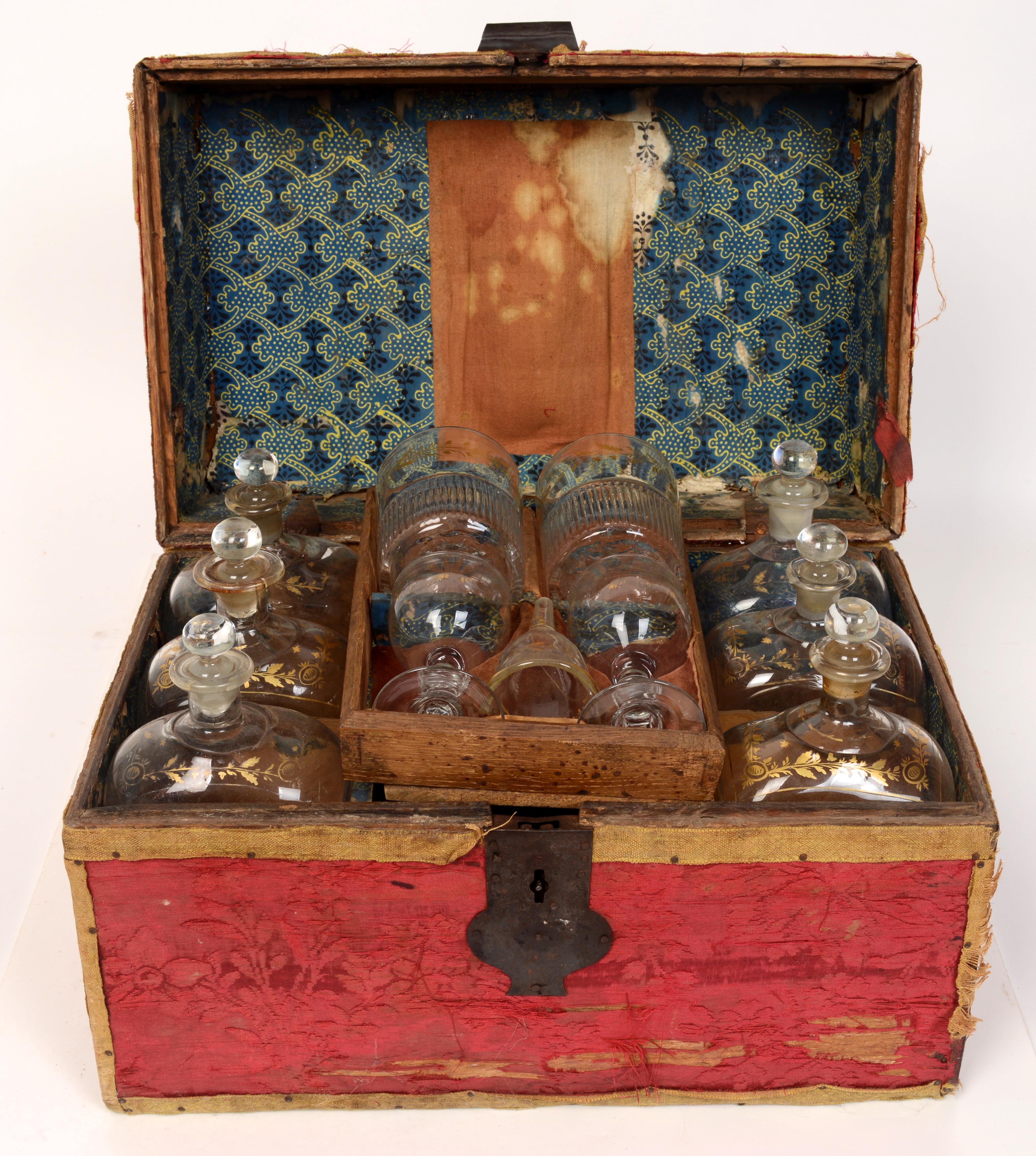 Fitted traveling case with original hand blown gilt decorated bottles with the original crimson brocade cover, late 18th century. The case retains the original working lock and key on a braided 18th century cord with tassels. 