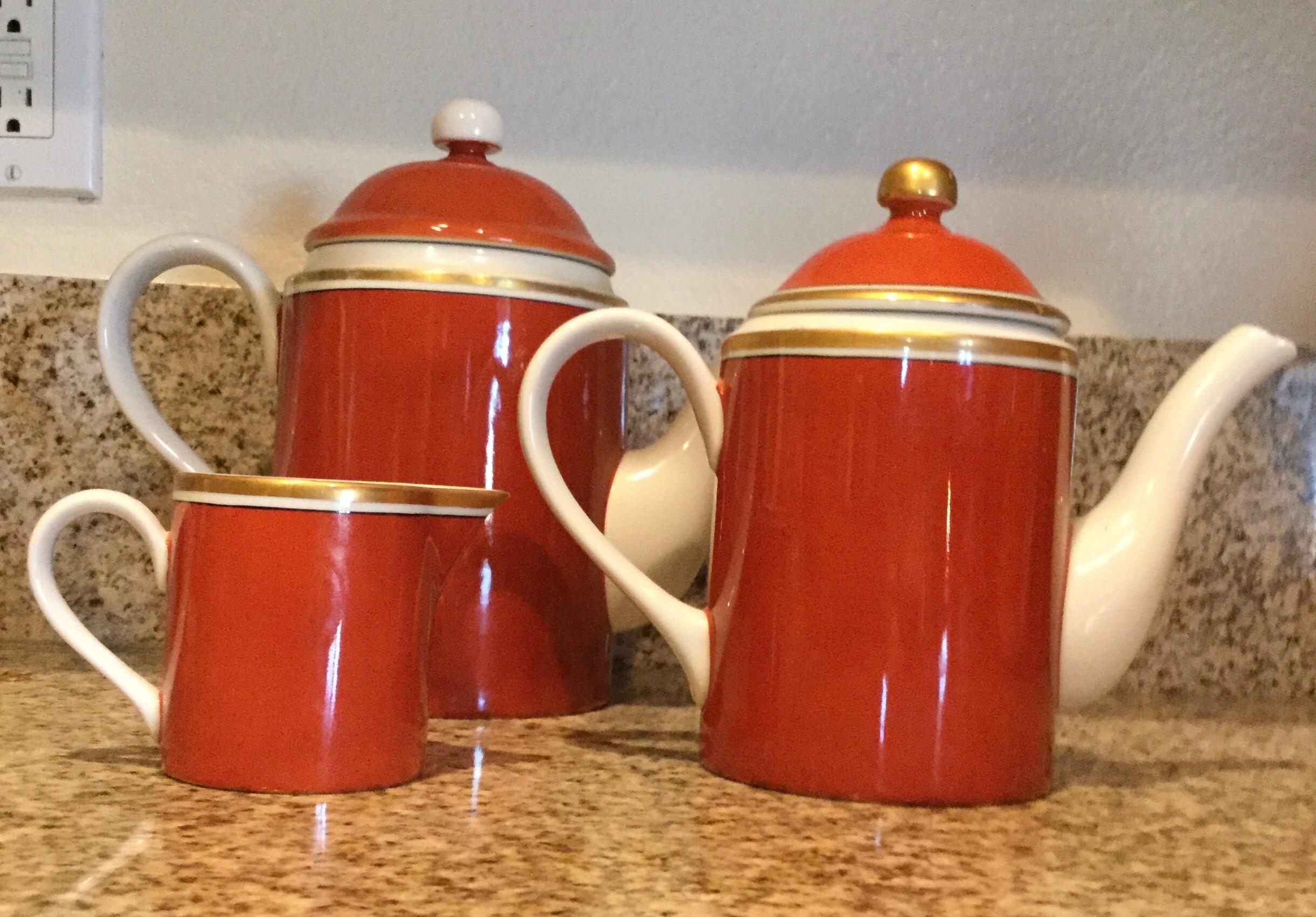 Fitz and Floyd signed 1979 set of coffee and tea pots with individual creamer. They appear never to have been used. This is part of a huge set recently acquired from a multi million dollar Palm Springs estate. Purchased in 1979 this Medallion d’Or