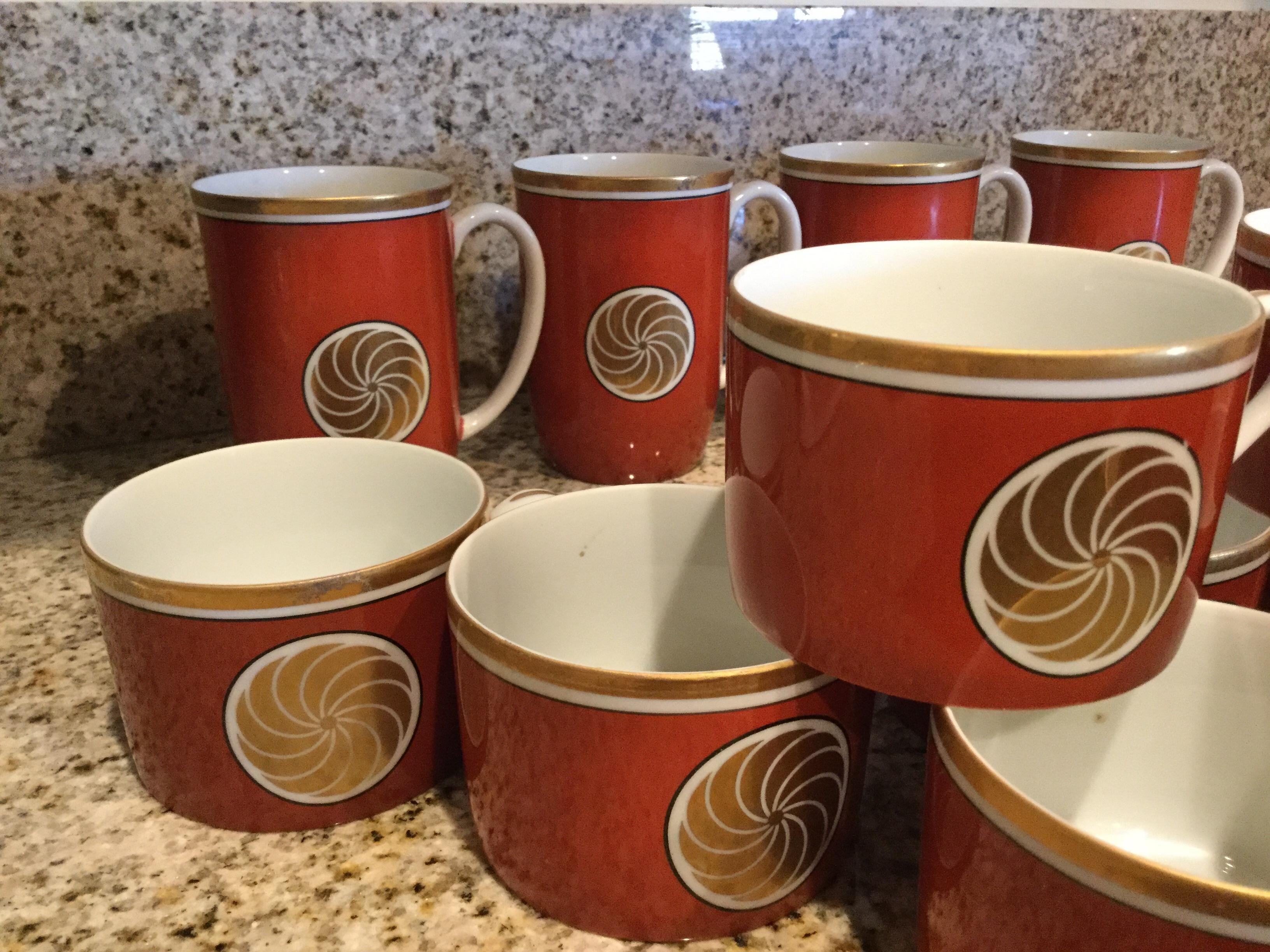 Fitz and Floyd were the premiere makes of china in the 70s and 80s. Their taste level and choice of patterns and colors made them legends! This Medallion d'Or in persimmon color is so chic! Set of 11 coffee cups and 4 coffee mugs. They appear never