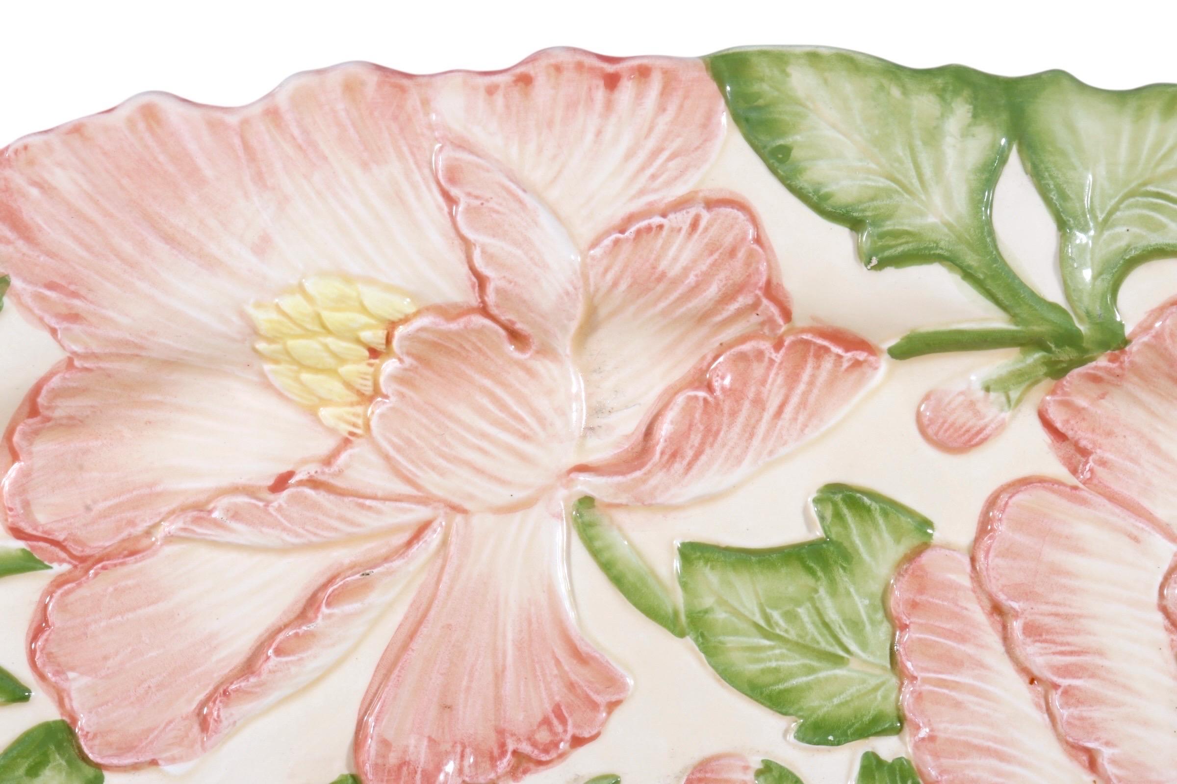 A ceramic serving platter made by Fitz & Floyd for their Tuileries collection. Made in Japan in 1988, the platter is embossed with pink flowers and foliage. Tuileries was a former royal palace in Paris, France. The gardens that formed part of the