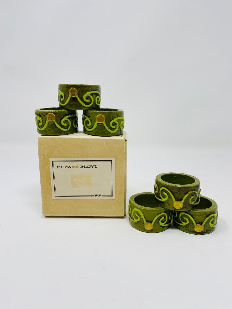 Beautiful mid-century set of 6 napking holders by Fitz & Floyd. These set is both chic and nostalgic. Each napking holder is in great condition and is stylized in its original mid-century design. A vivid avocado green shade highlights an arabesque
