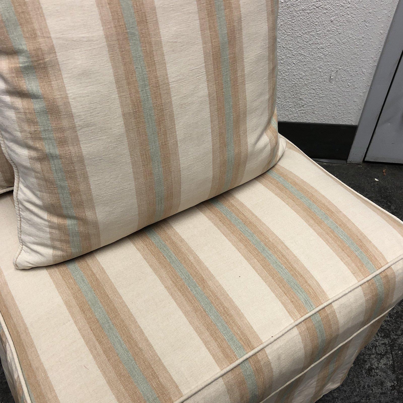 A fully dressed Billy Baldwin slipper chair by Fiztgerald. Upholstered in a fresh striped canvas. The cool aqua, earthen shades of brown and almost silken colored beige canvas upholstery would be right at home in a beach house, or other open breezy