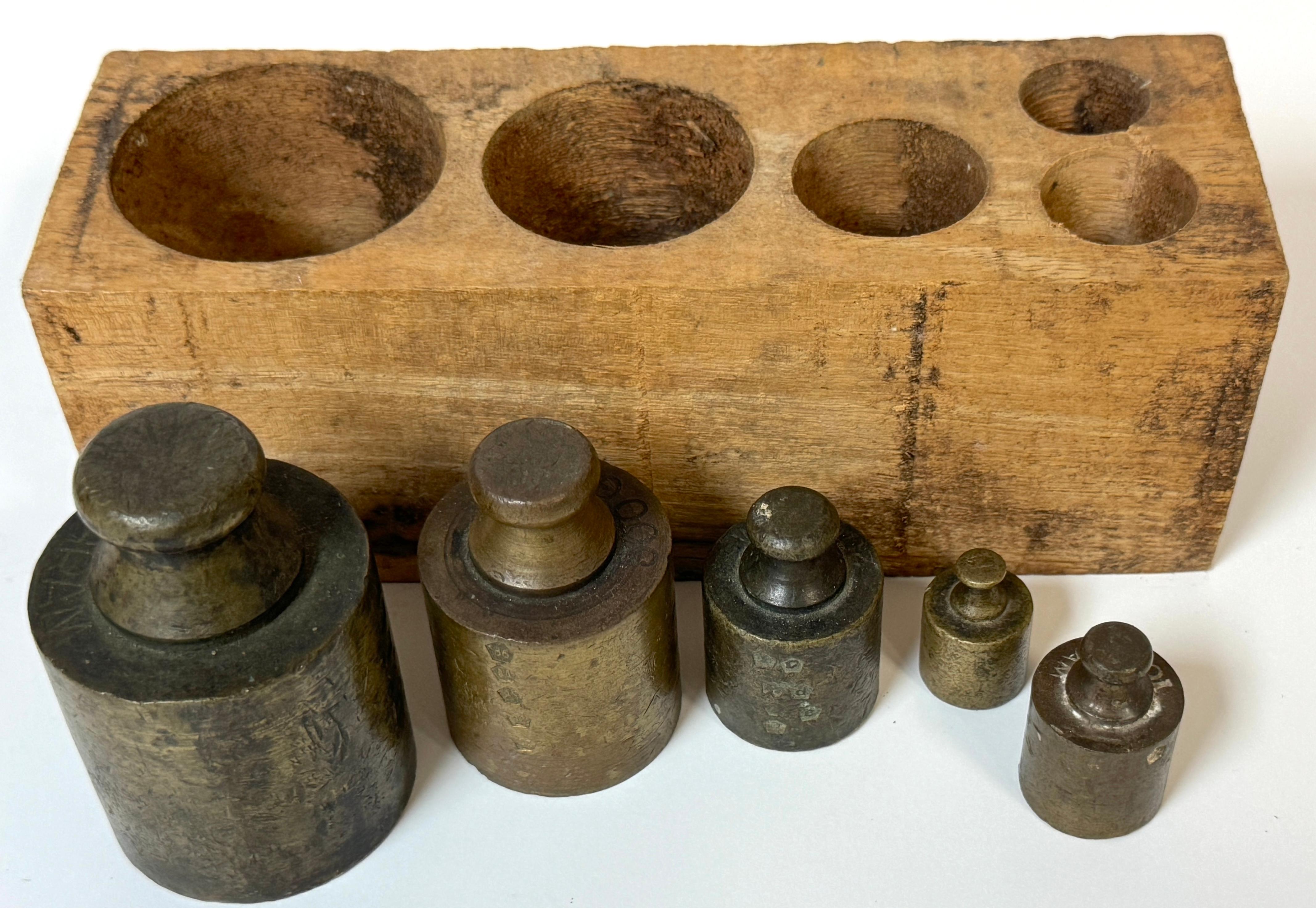 Set of 5 Antique French Bronze (Apothecary) Metric Weights with Original Wooden Block, Circa 1880

A handsome and authentic set of 19th-century French bronze metric weights, housed in their original carved hardwood block. This graduated set includes