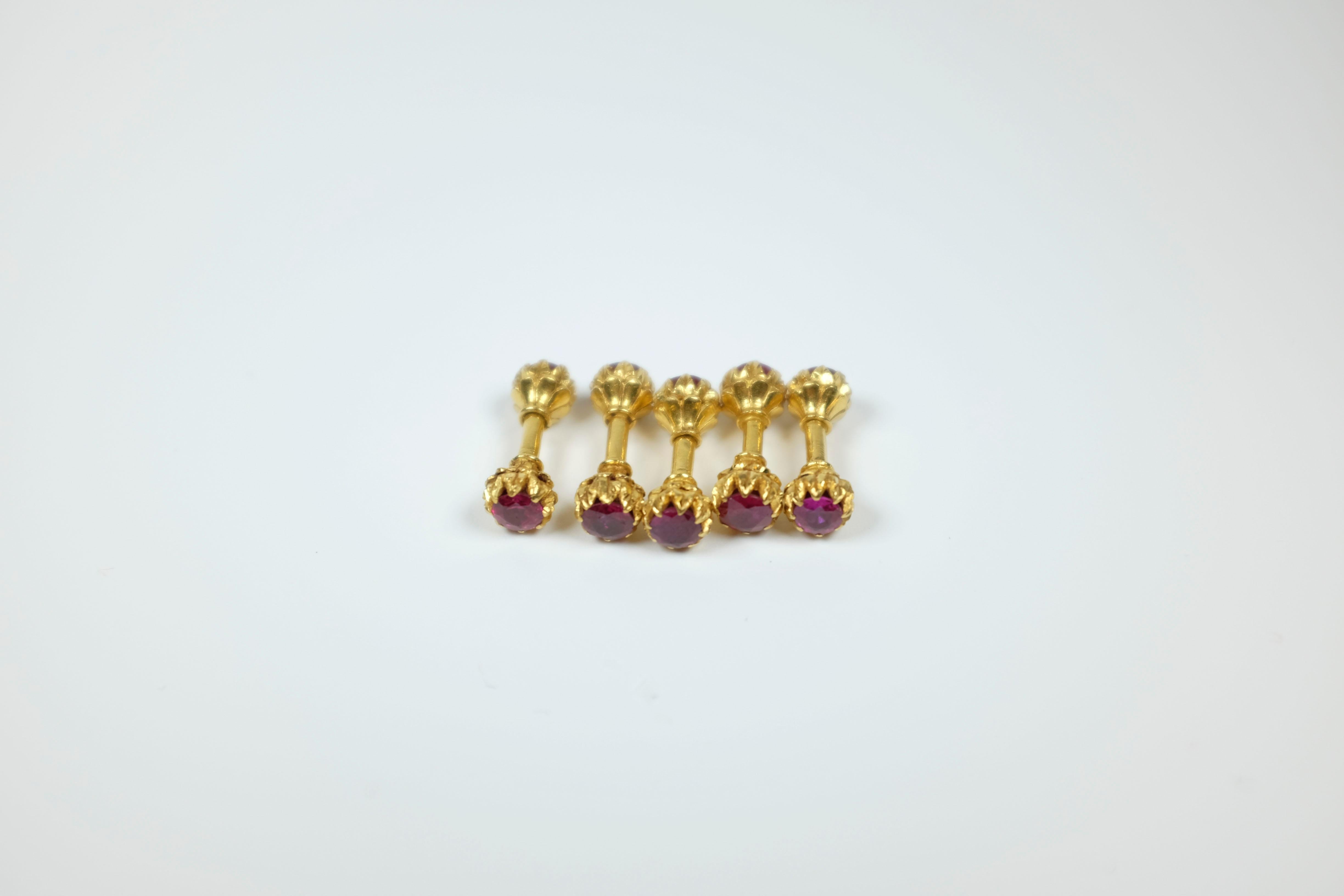 Decorative jewels set. 'Buttons'. Rare. Collectors item. There are five. Each one carries two unheated Burma rubies, one on each end, approximately 1 carat each. Estimated 10 carats total weight. Each 'button' screws apart/together. Very good,