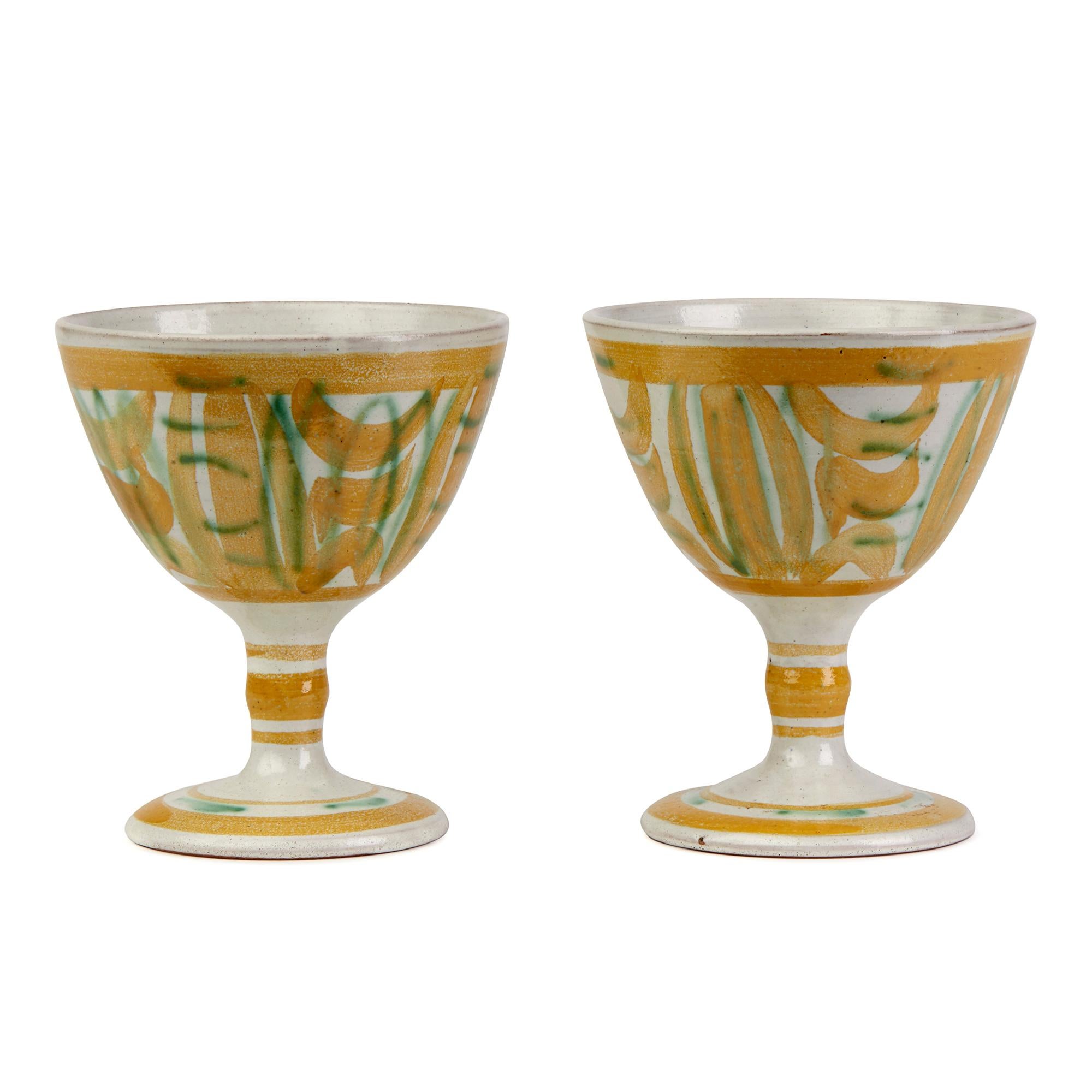 A stylish set five vintage Studio Pottery goblets made by renowned potter Alan Caiger Smith at Homer Street in London between 1956 and 1963. The goblets stand on a rounded pedestal base with narrow shaped stem with a rounded conical bowl and each is