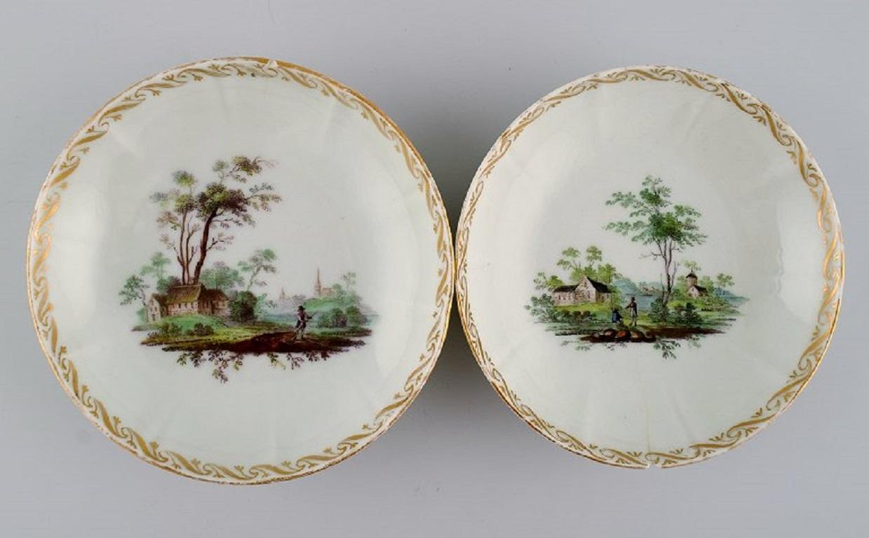 Five antique Royal Copenhagen porcelain bowls with hand-painted landscapes and gold decoration. 
Museum quality. 
Early 19th century.
Measures: 14.5 x 3.5 cm.
In good condition. All with small chips and light wear in the gold.
Signed.
1st factory