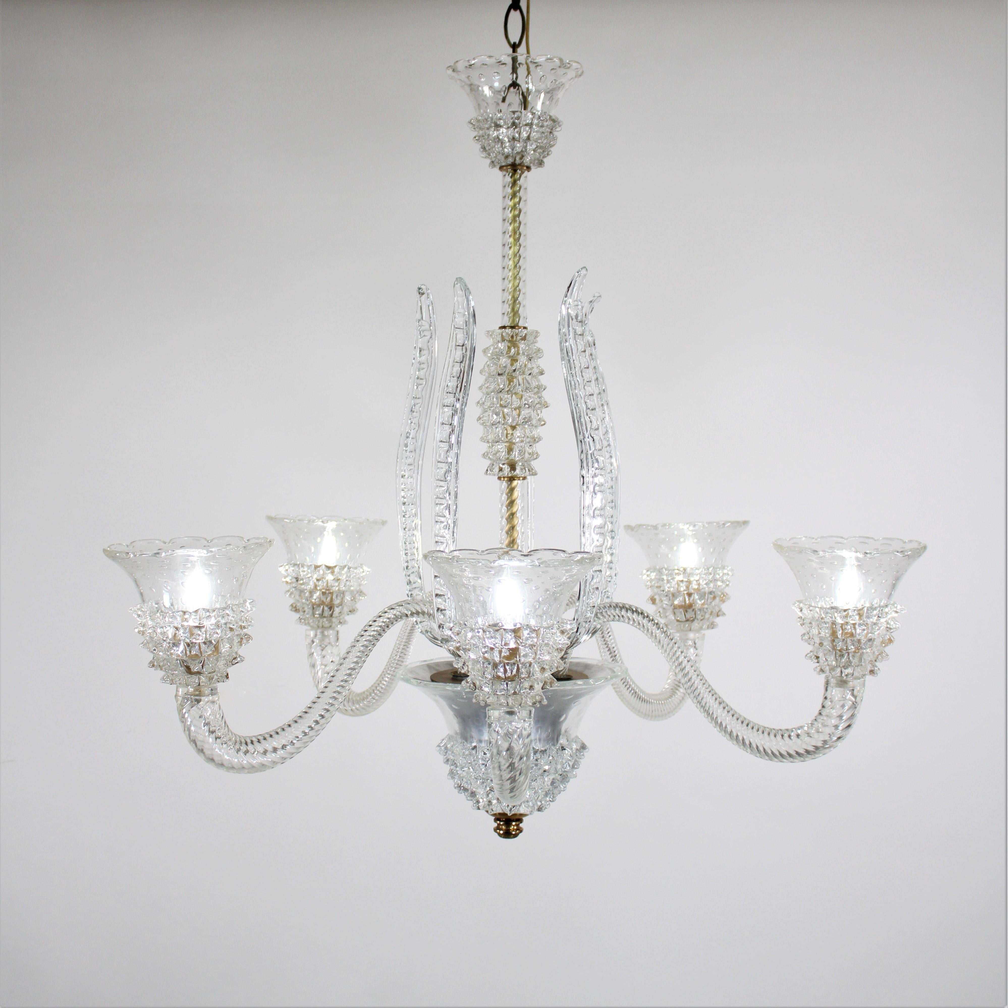 Experience the timeless elegance of this exquisite Murano chandelier, featuring five gracefully scrolling arms adorned with sophisticated glasswork. This piece showcases the renowned bullicante and rostrato techniques, which echo the styles