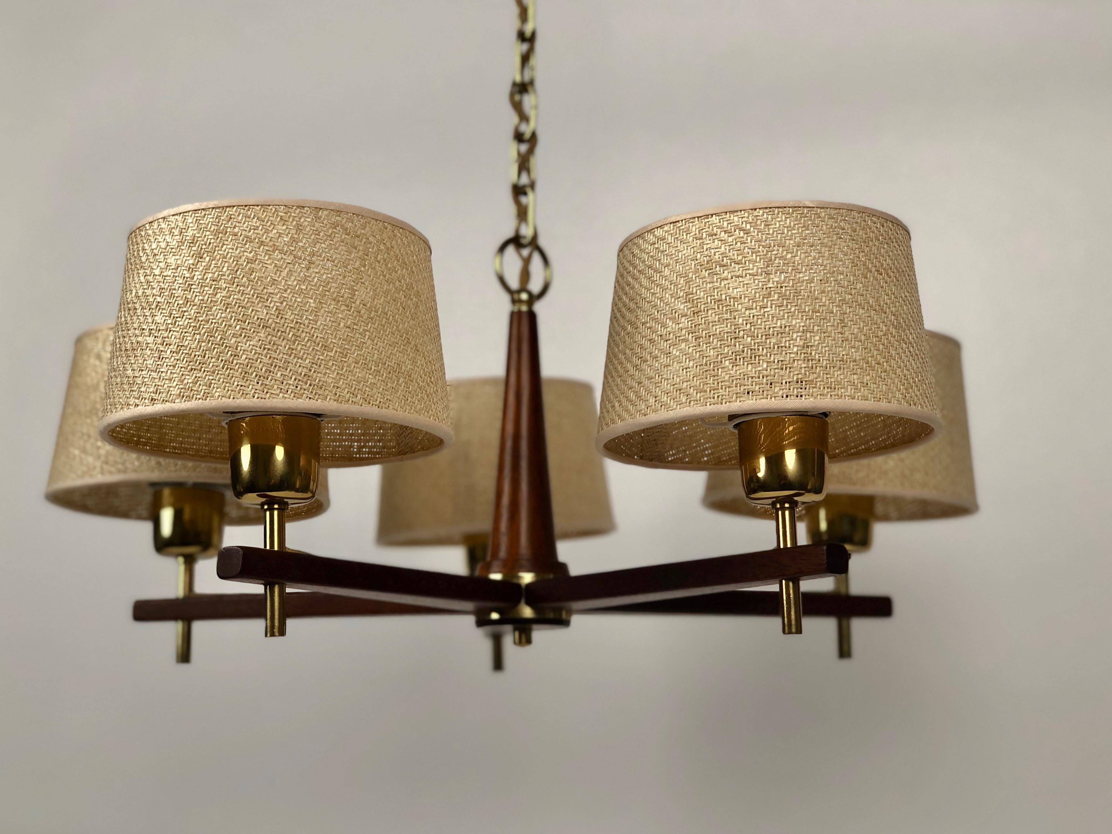 Five are chandelier in teak wood and brass with cane shades.
A typical design from the 1960's, 
The lamp is made in a high quality that is typical for J.T. Kalmar productions.
The wood is polished with wax. Beautiful details include the silk covered