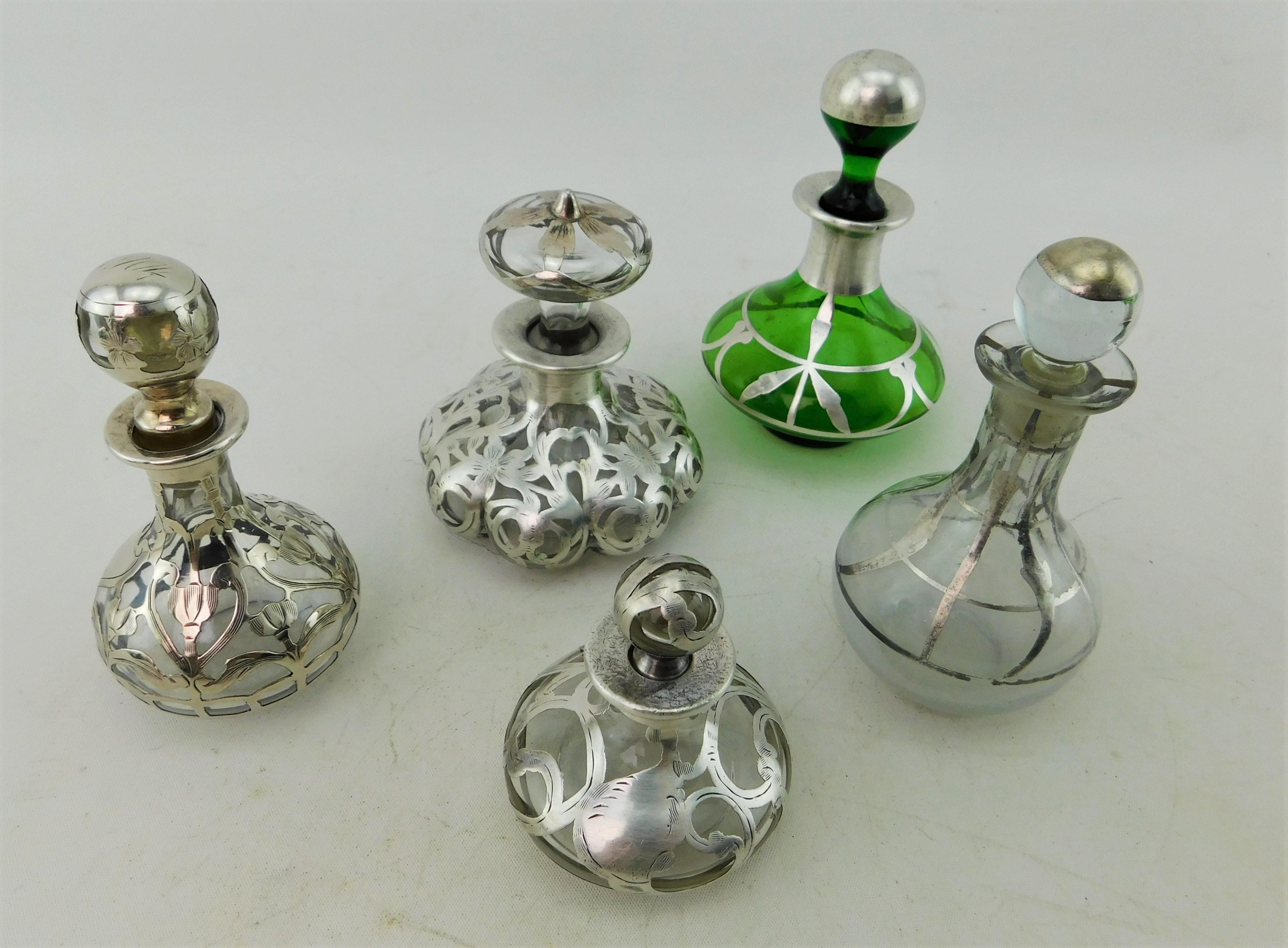 This collection of five late 19th century/early 20th century (circa 1890-1910) perfume bottles with lids/stoppers (note stoppers are interchangeable).  Of European make possibly English but no makers marks except 1904 engraved on one bottle.
They